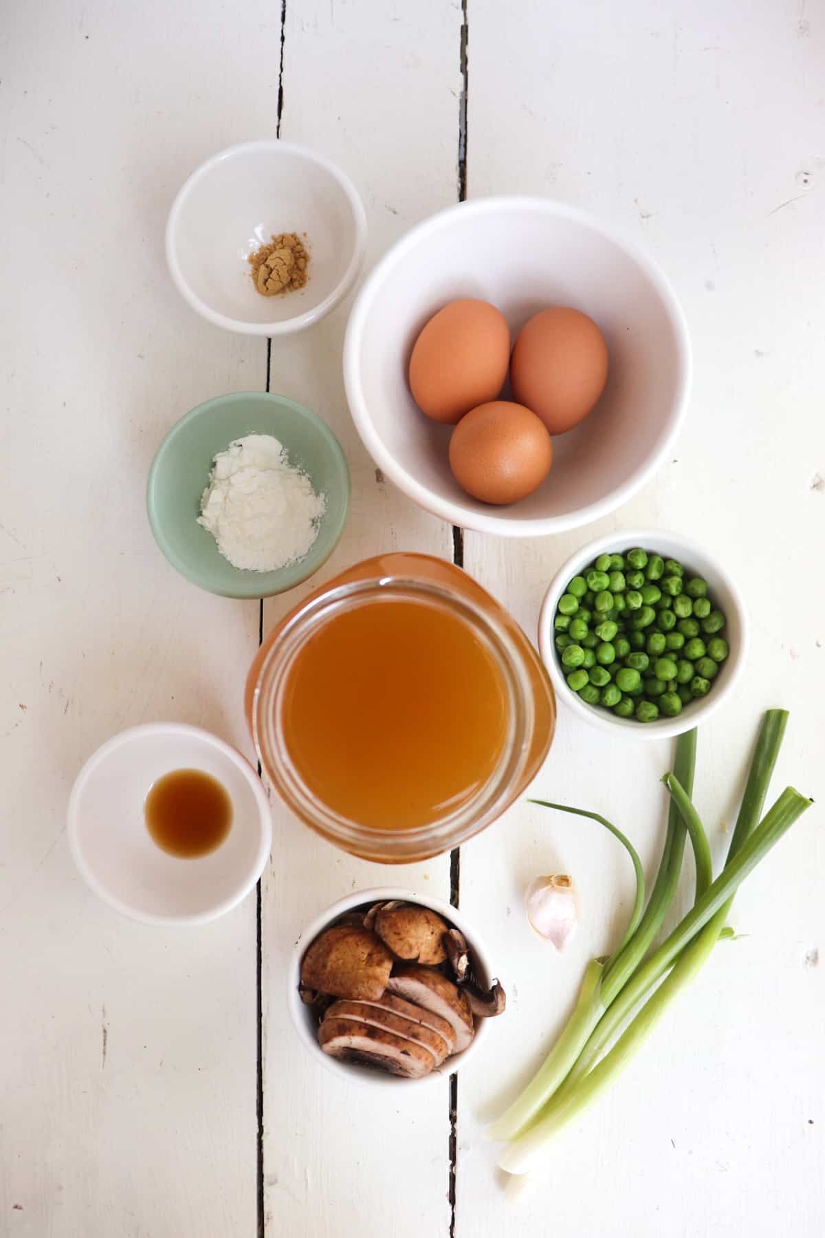 ingredients for egg drop soup on a white background.