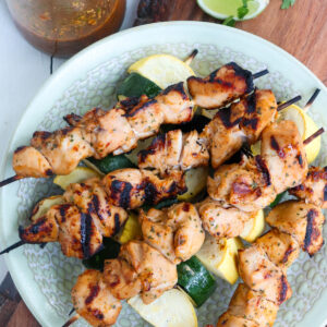 asian chicken marinade and kabobs that have been made with that marinade on a plate.