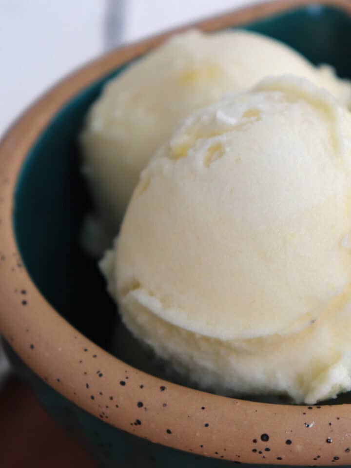 bowl with three scoops of pineapple sorbet.