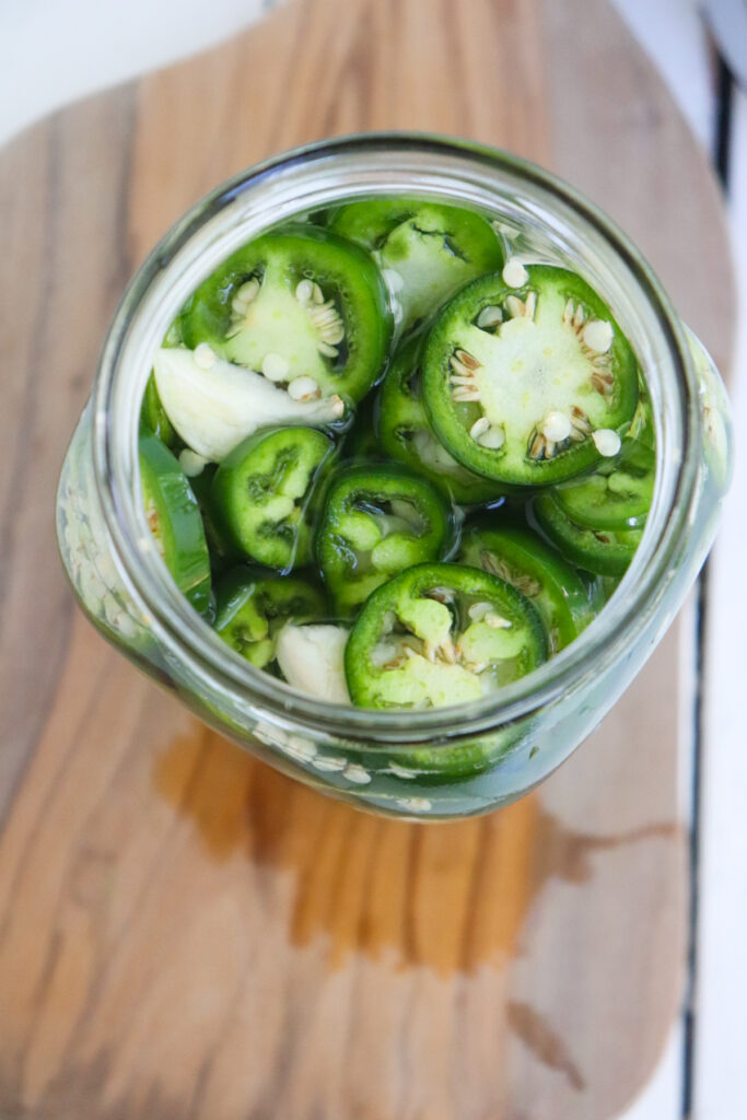 overhead sliced jalapenos once the liquid has been added.