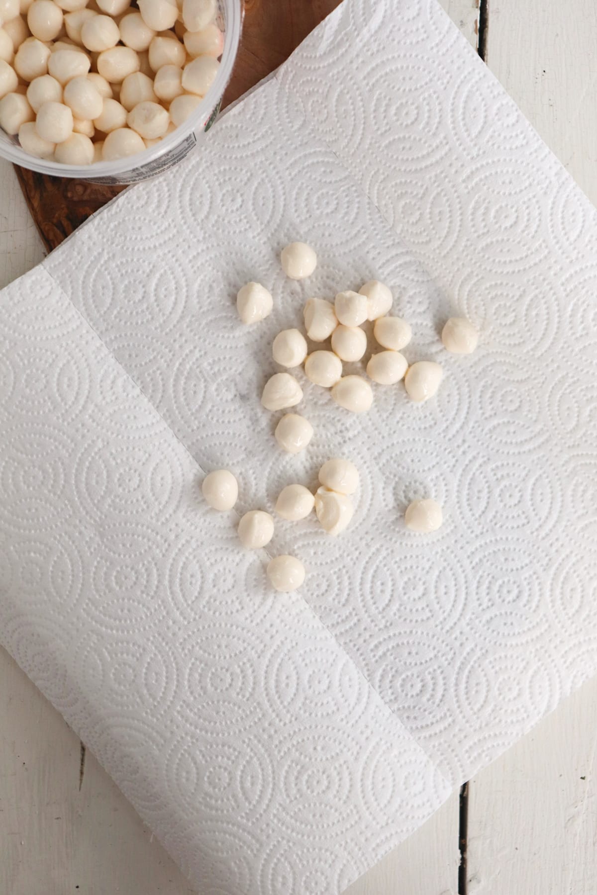 mozzarella balls that are being dried on a paper towel.