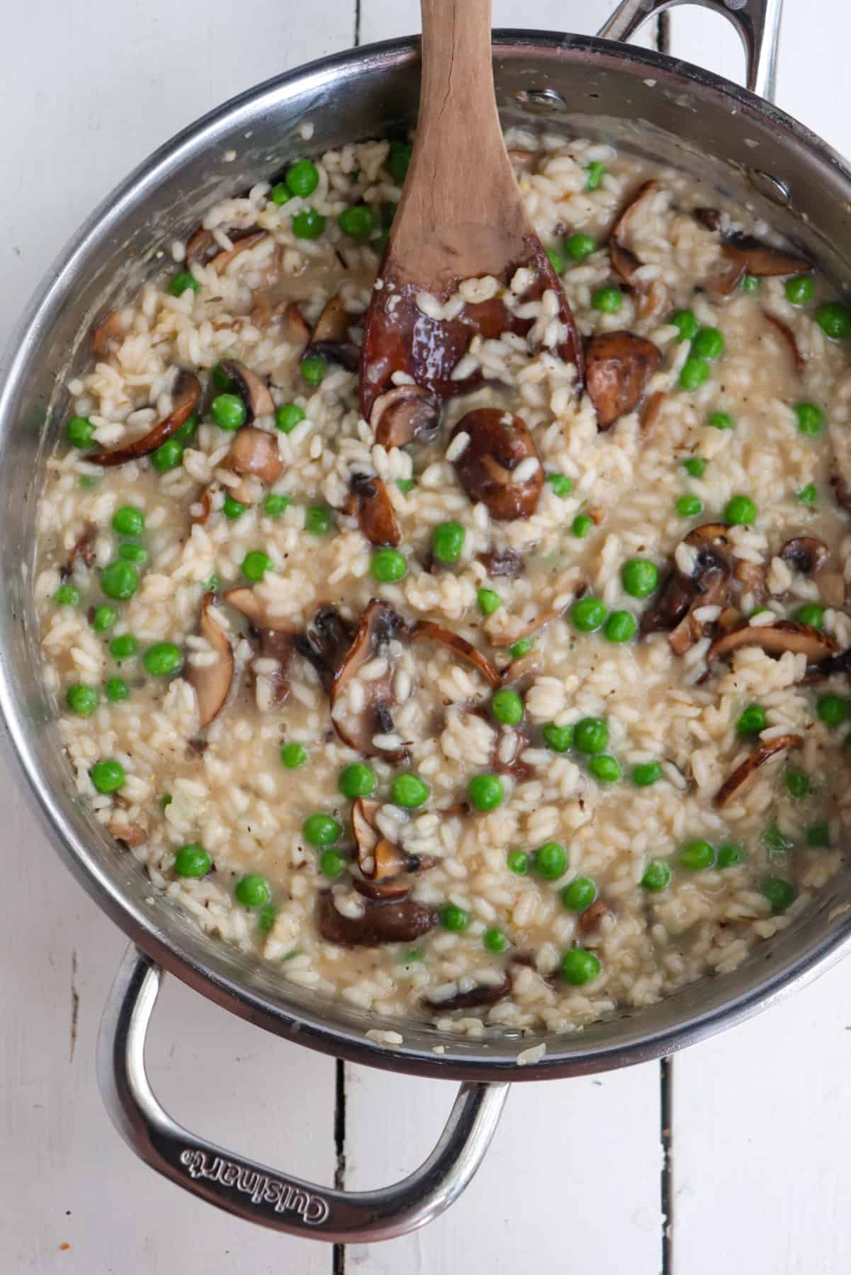 finished mushroom pea risotto in a stainless steel pan.