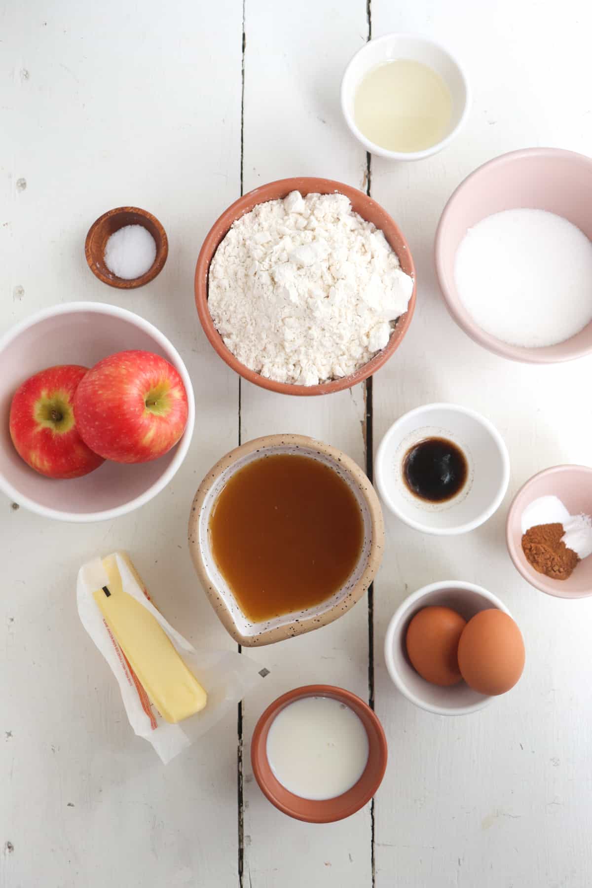 ingredients for apple cider muffins on a white background.