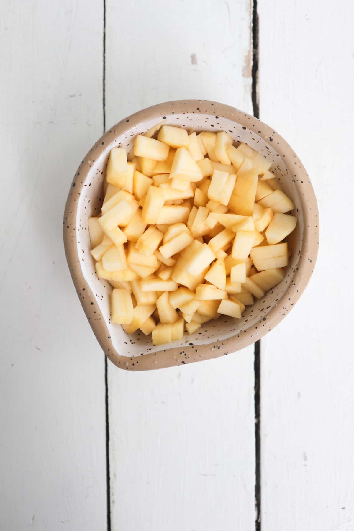 peeled and diced apples in a small bowl.