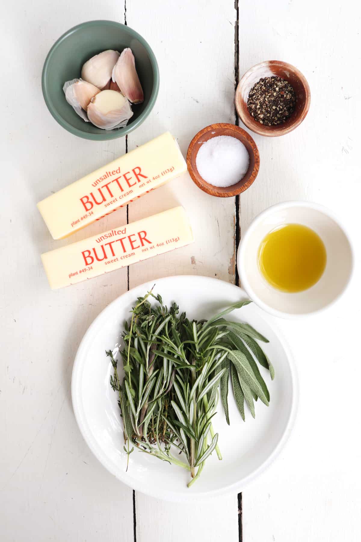 ingredients for herb butter on a white background.