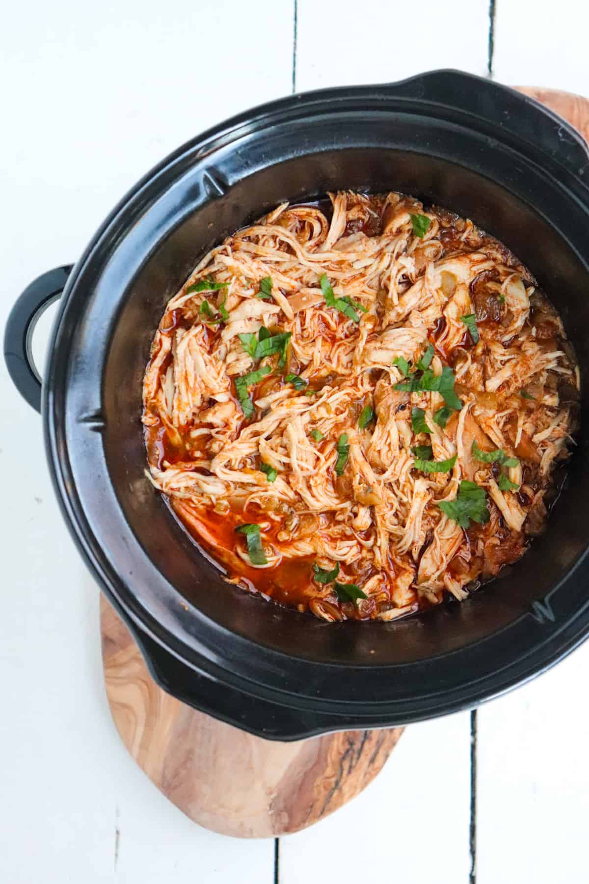 shredded chicken with herbs in slow cooker. 
