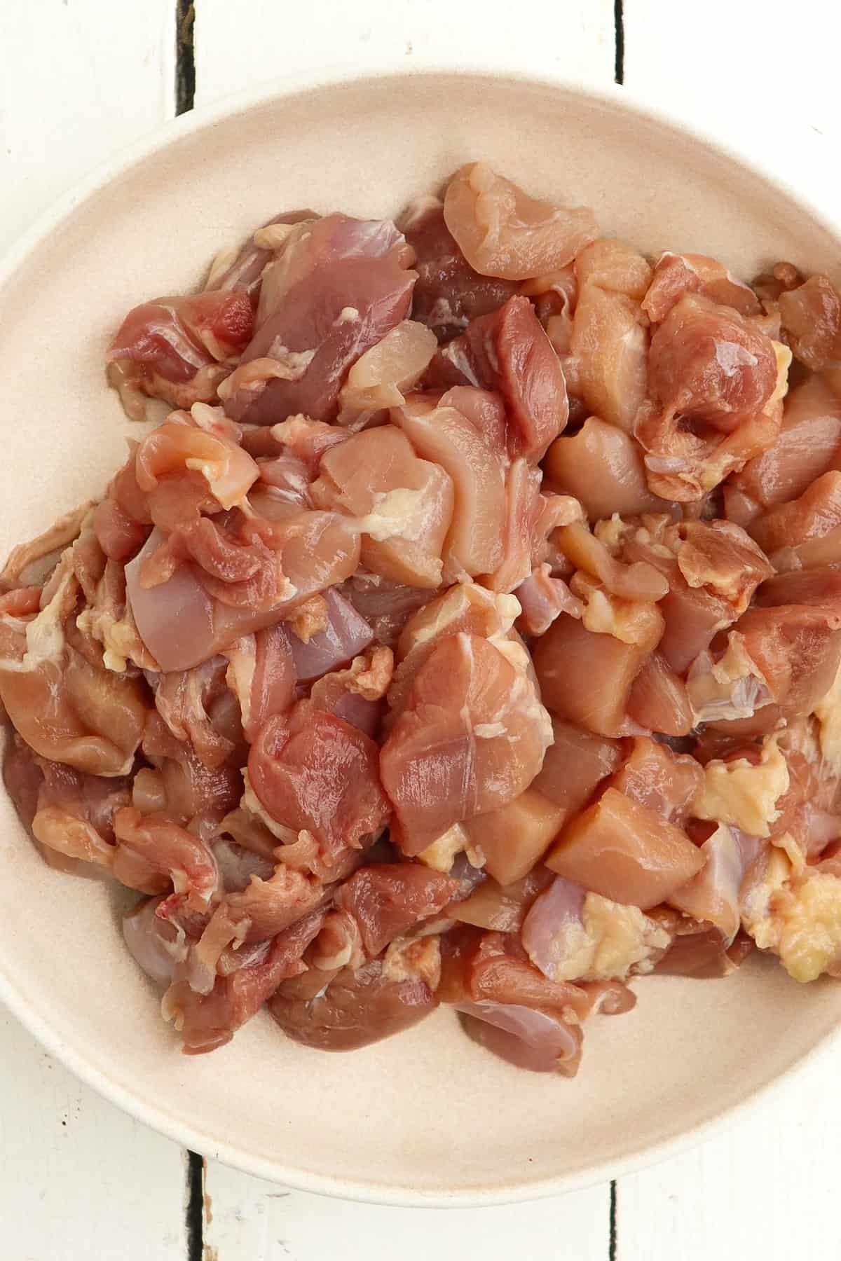 diced chicken thighs in a bowl.