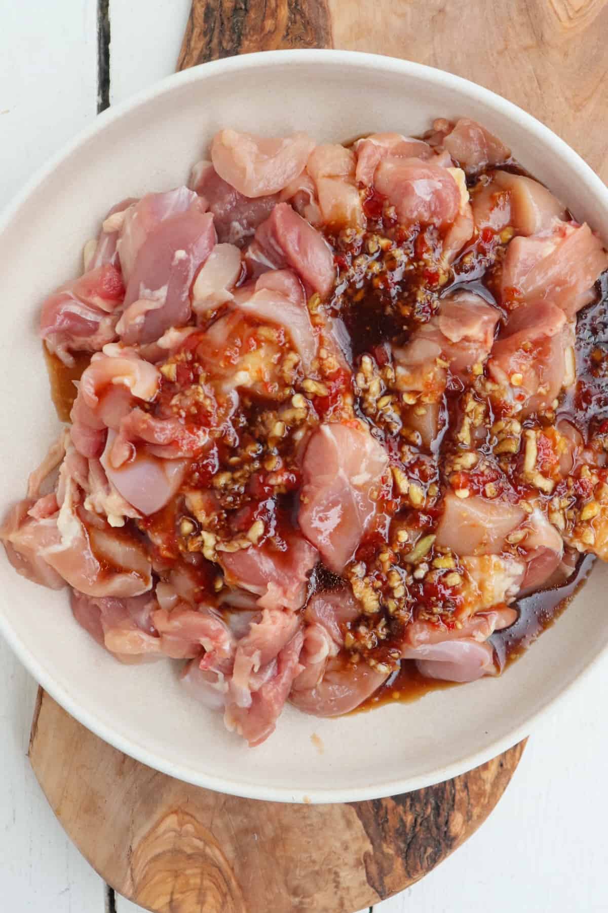 bowl of marinated chicken thighs.