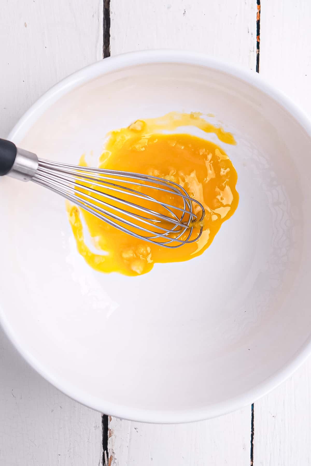 egg yolk and garlic mixed in a bowl.