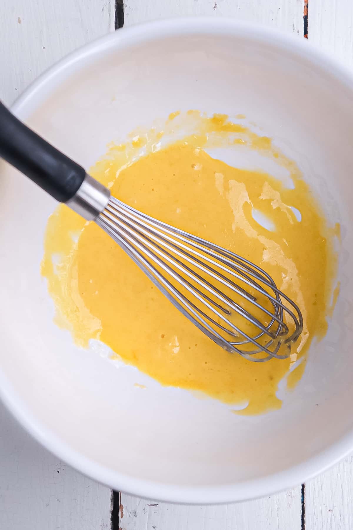 oil beginning to be added to egg yolk.