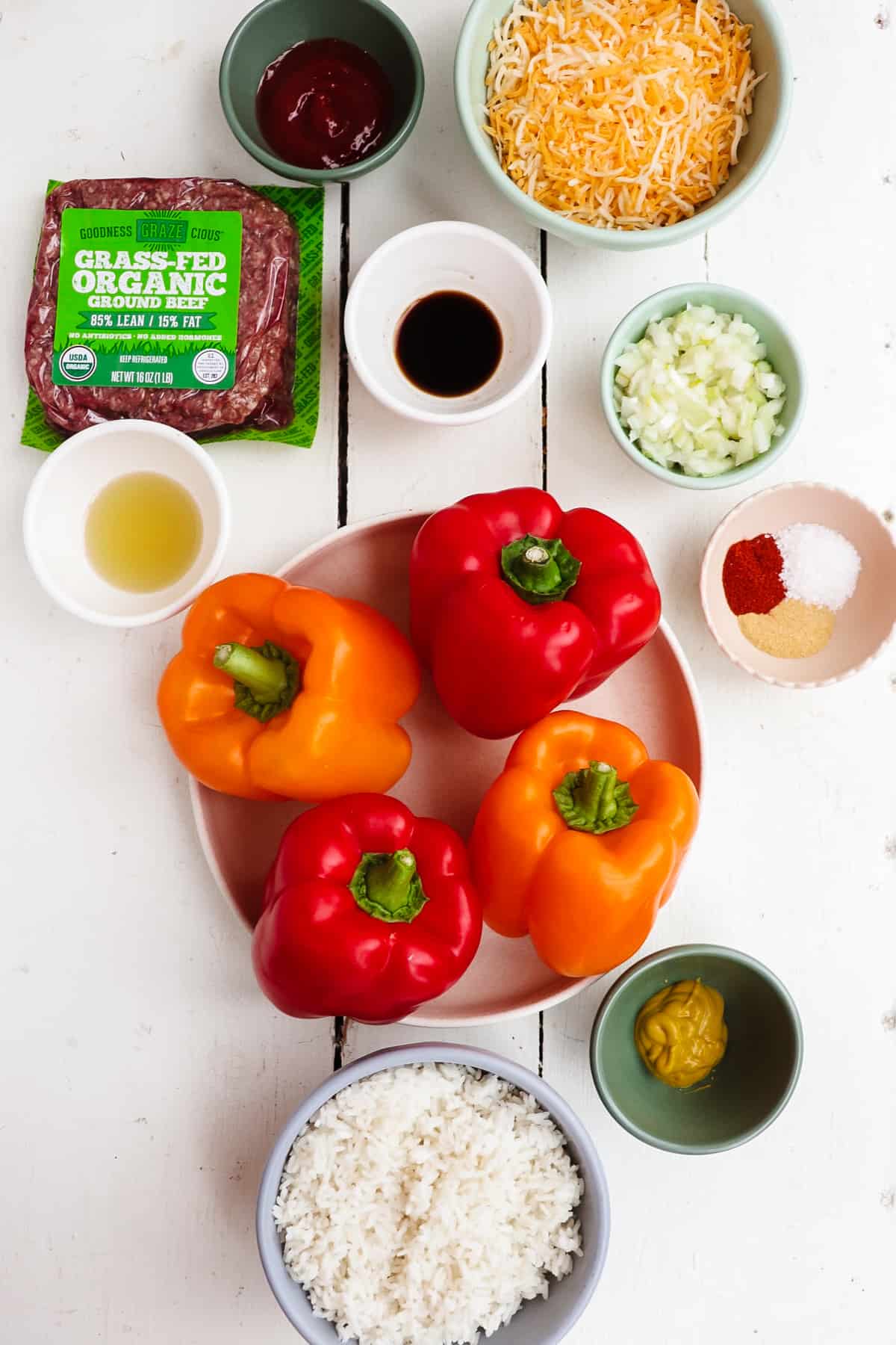 ingredients for cheeseburger stuffed peppers on a white table. 