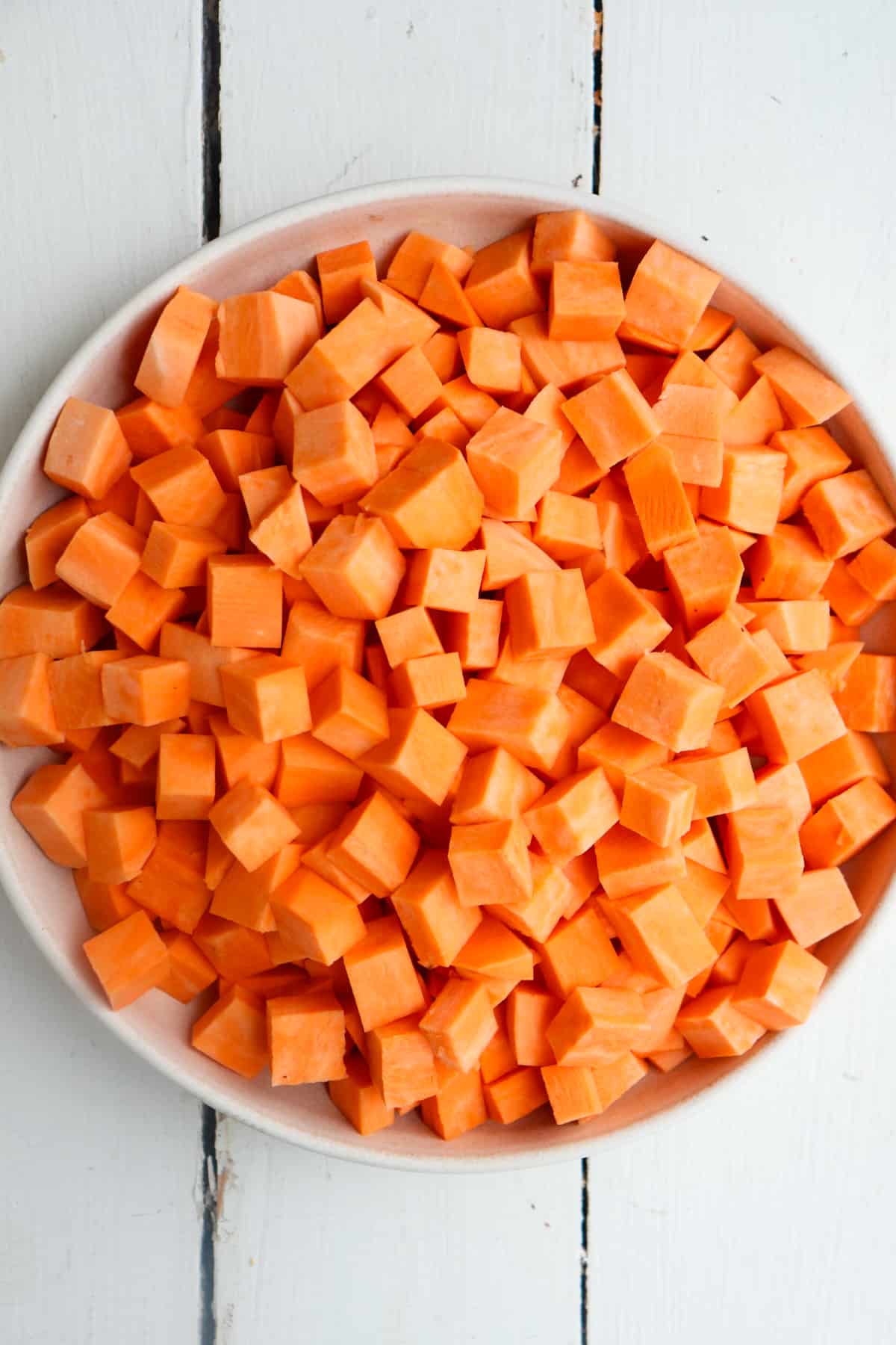 bowl of peeled and diced sweet potatoes.