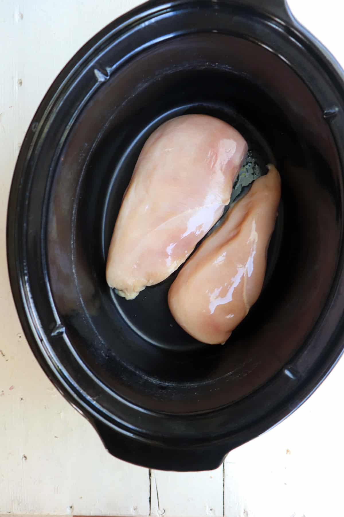 two chicken breasts in slow cooker. 