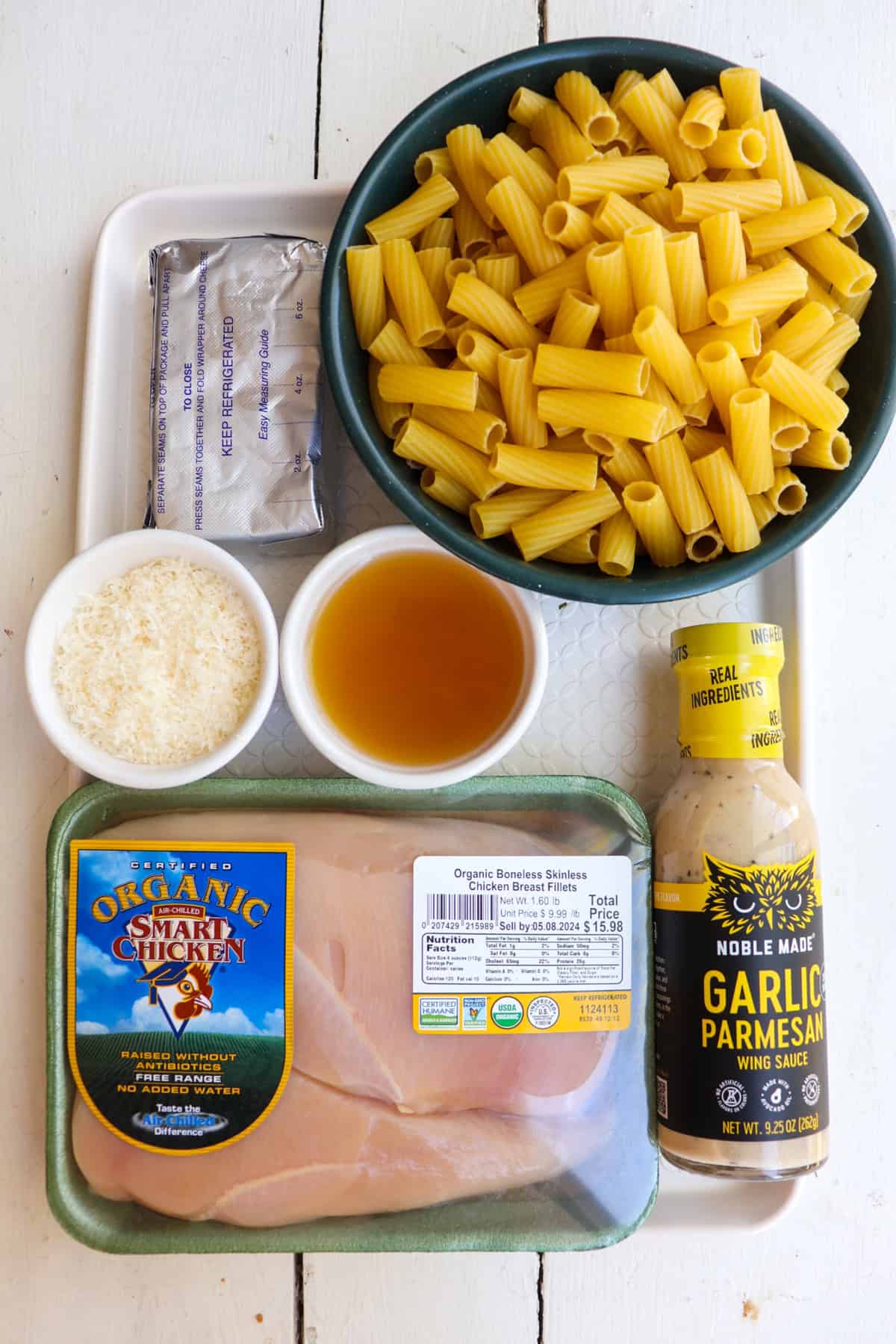 ingredients for garlic parmesan crockpot pasta on a white tray.