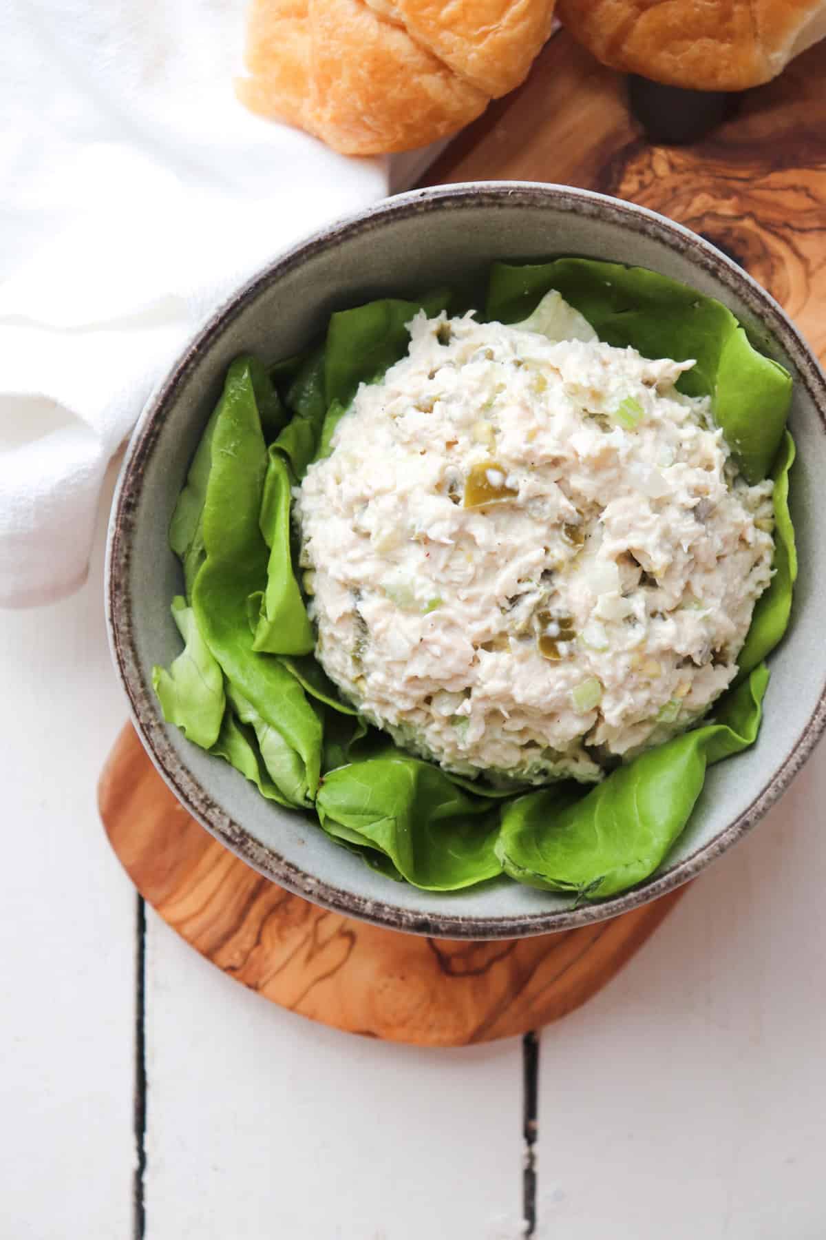 bowl of jalepeno chicken salad on a bed of lettuce.