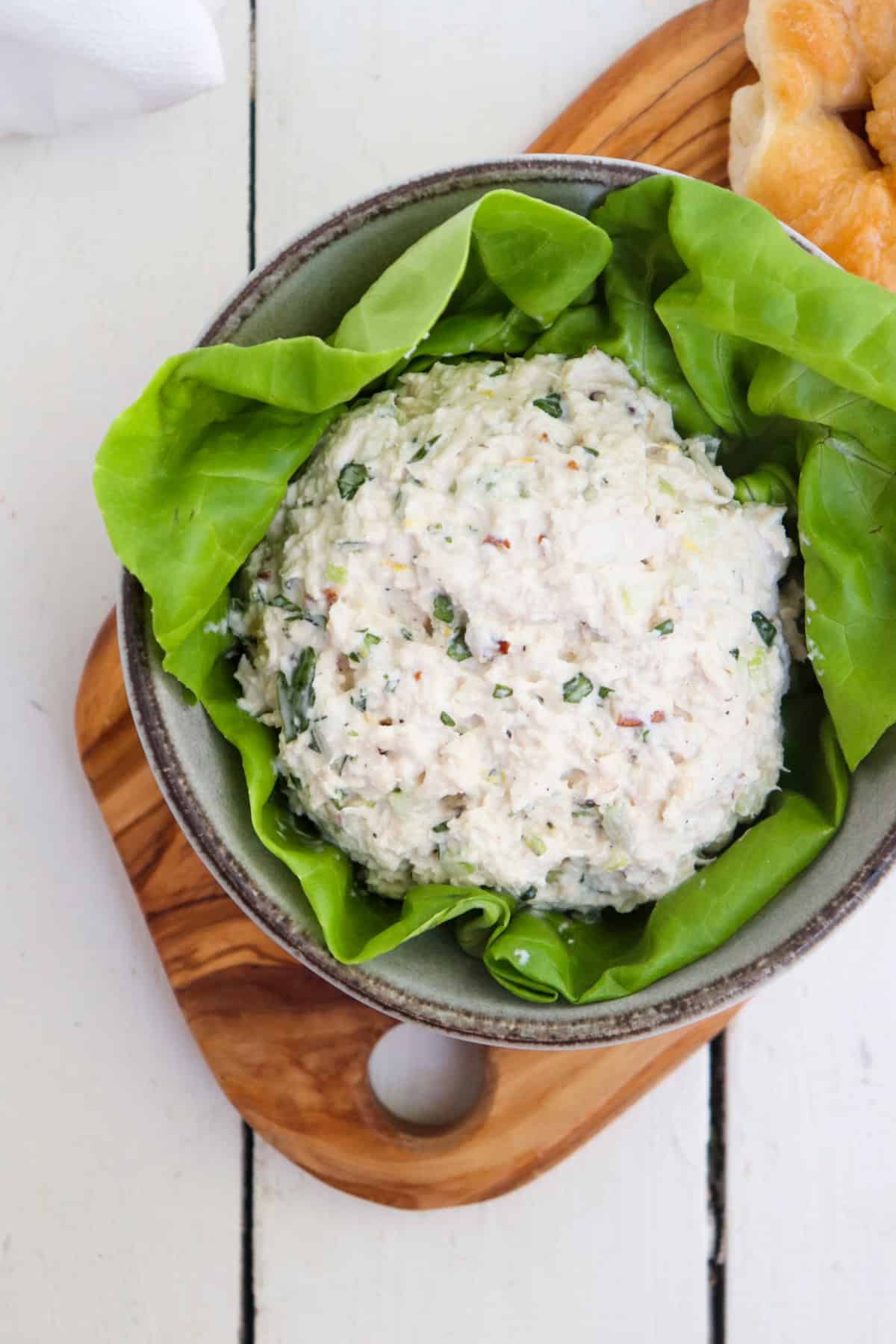 scoop of chicken salad in a bowl of lettuce.