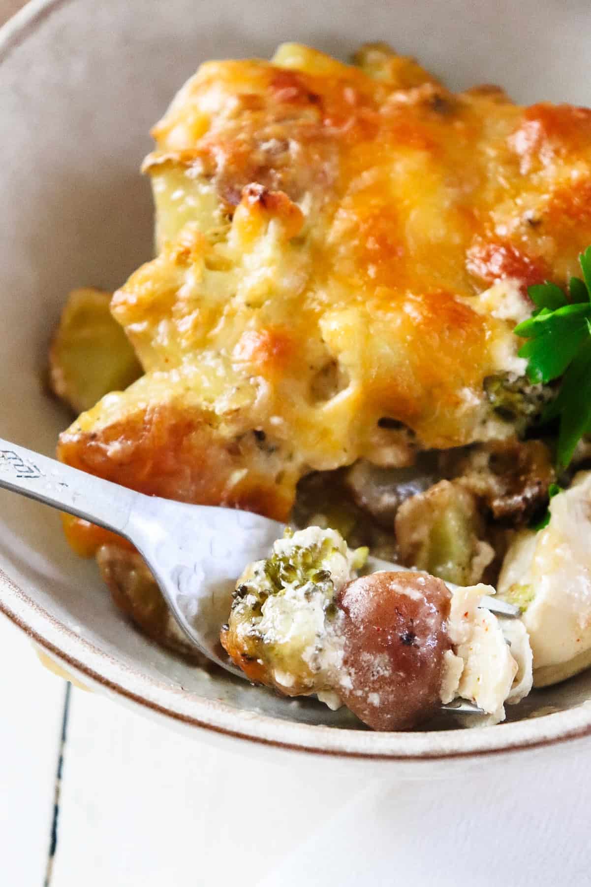 bowl of chicken casserole with a fork scooping a bite.