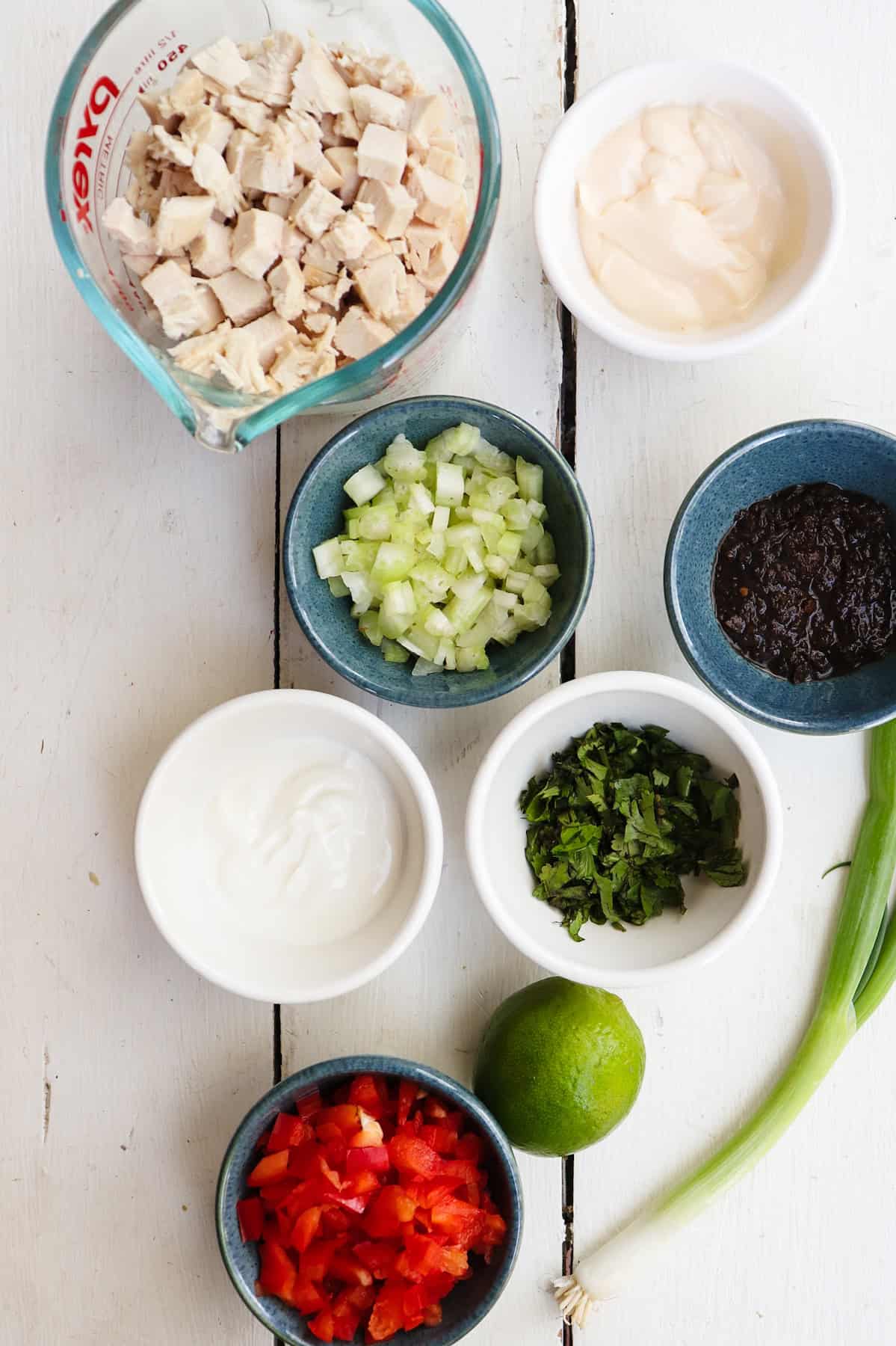 jerk chicken salad ingredients on a white table.