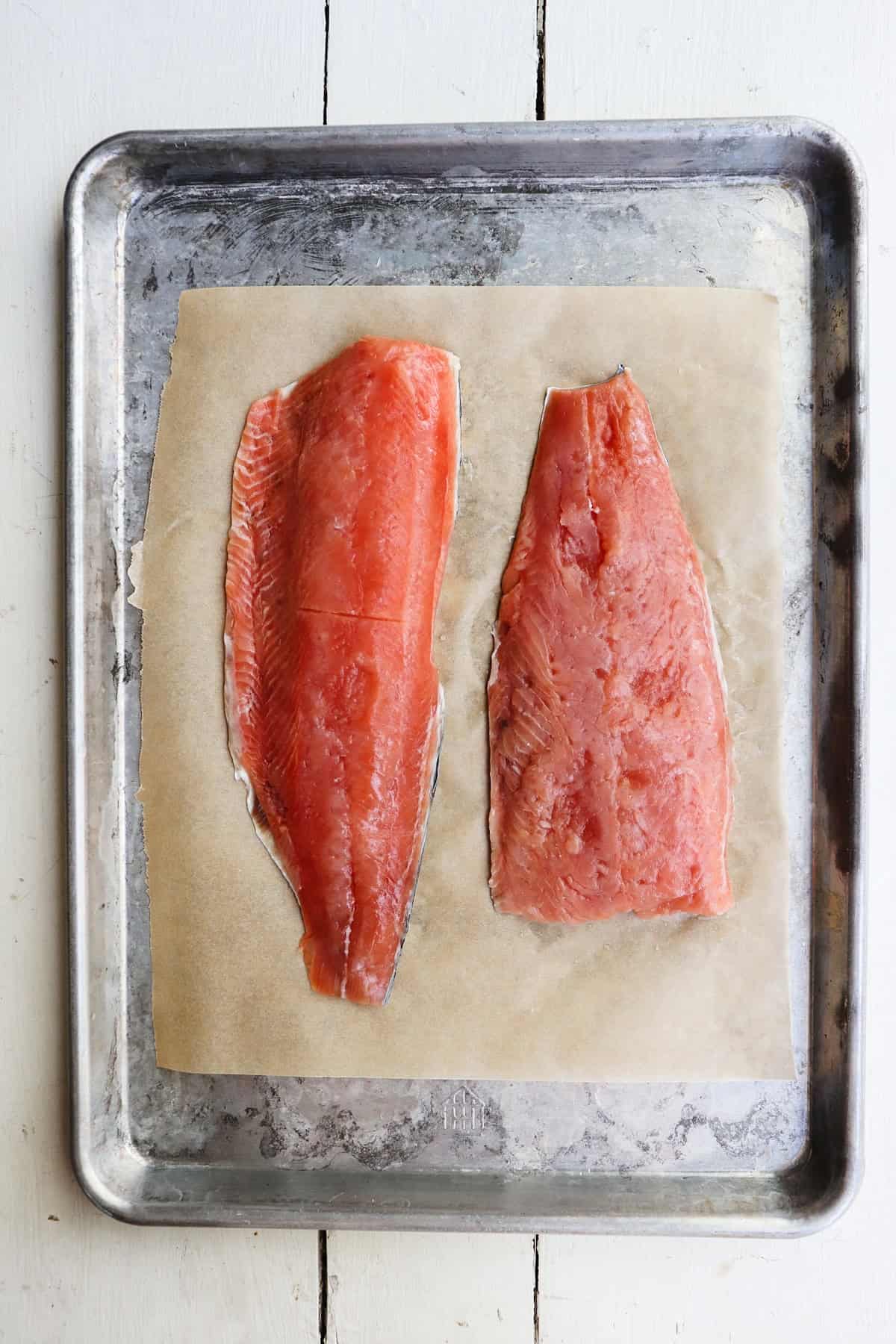 two sides of salmon on a baking sheet.