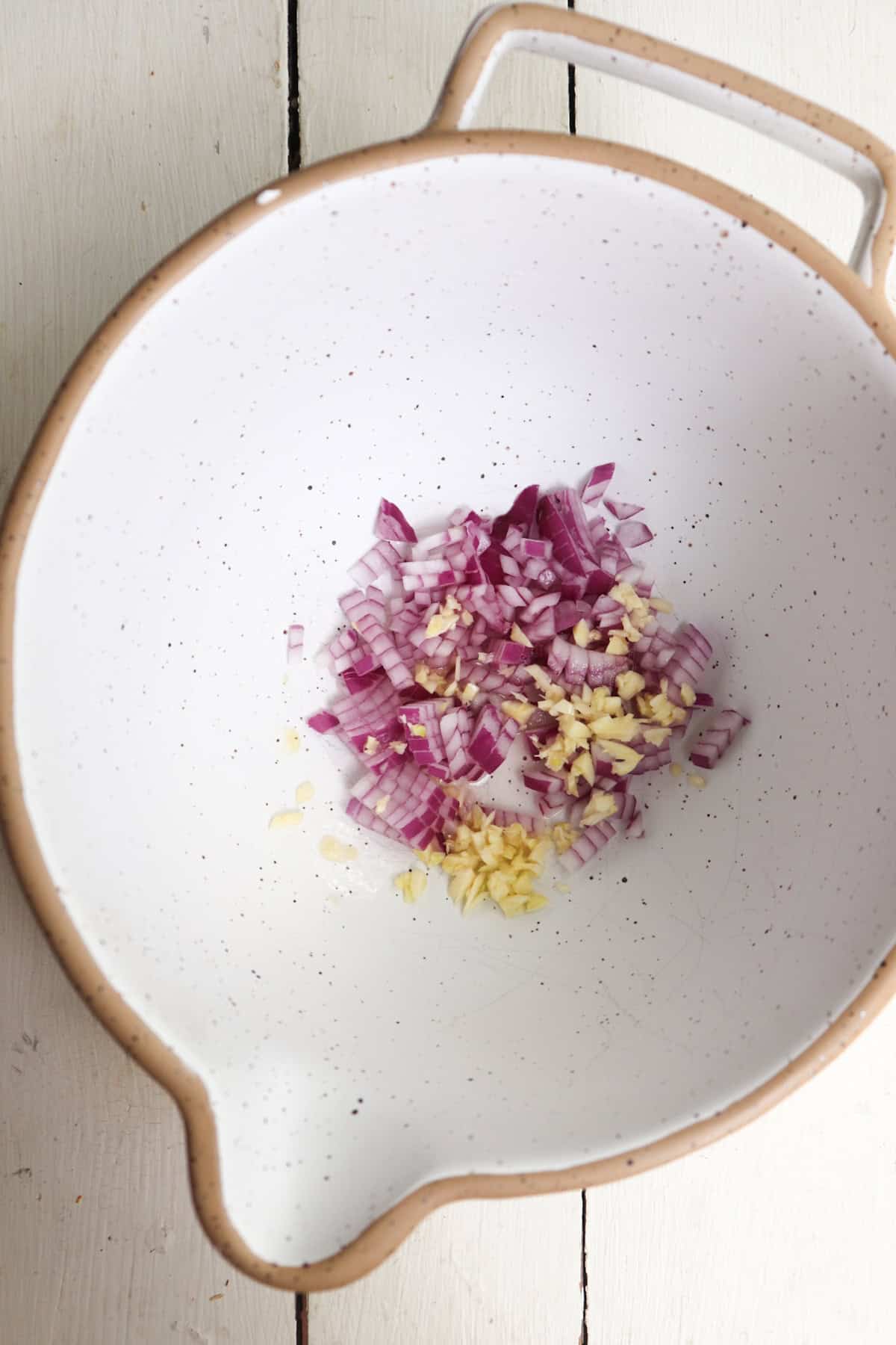 Diced onions and garlic in large mixing bowl with lemon juice.