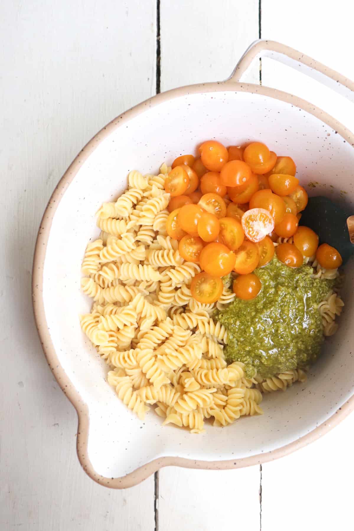 all ingredients added to a white mixing bowl but unmixed.