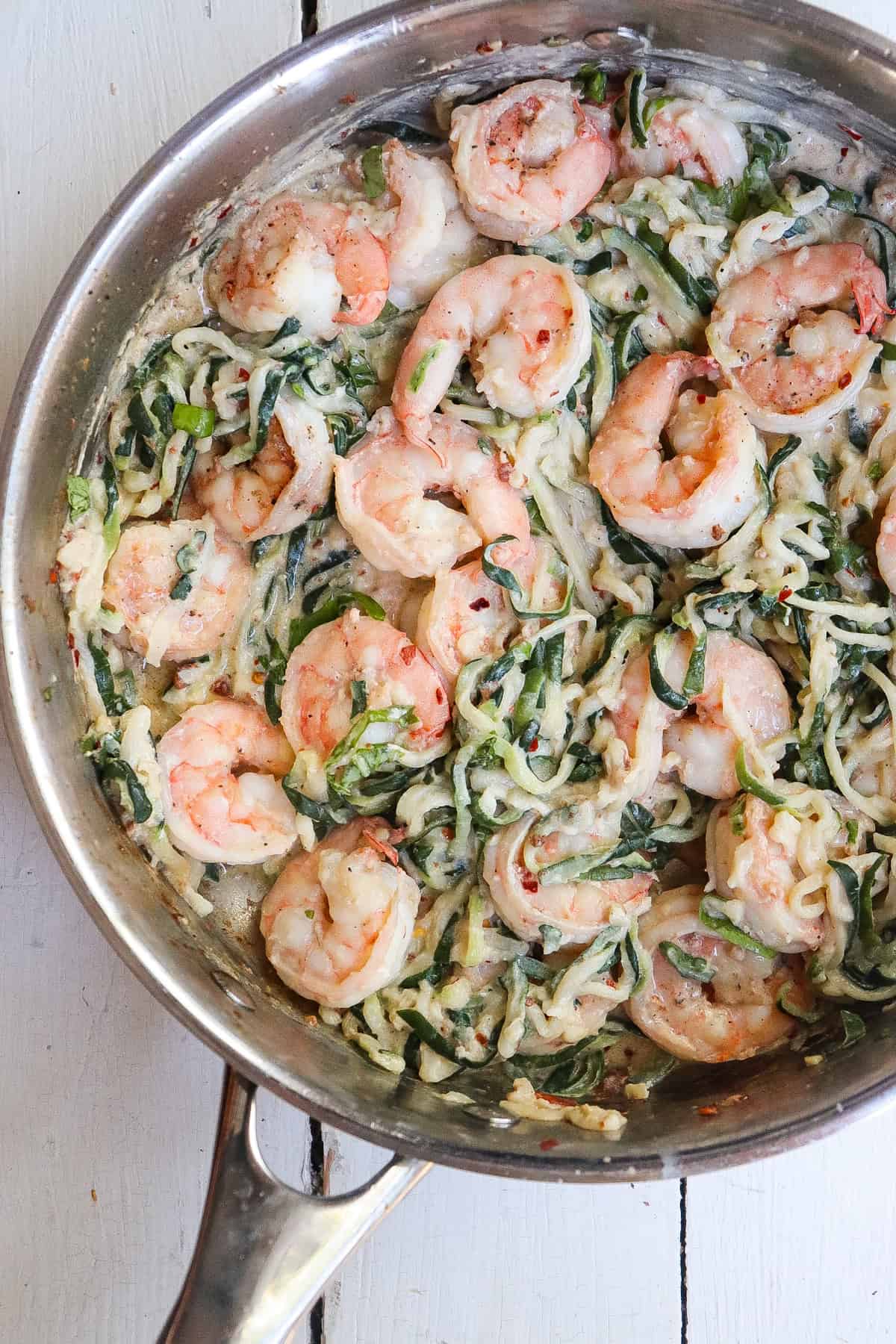 finished shrimp and zucchini noodles dish in skillet.