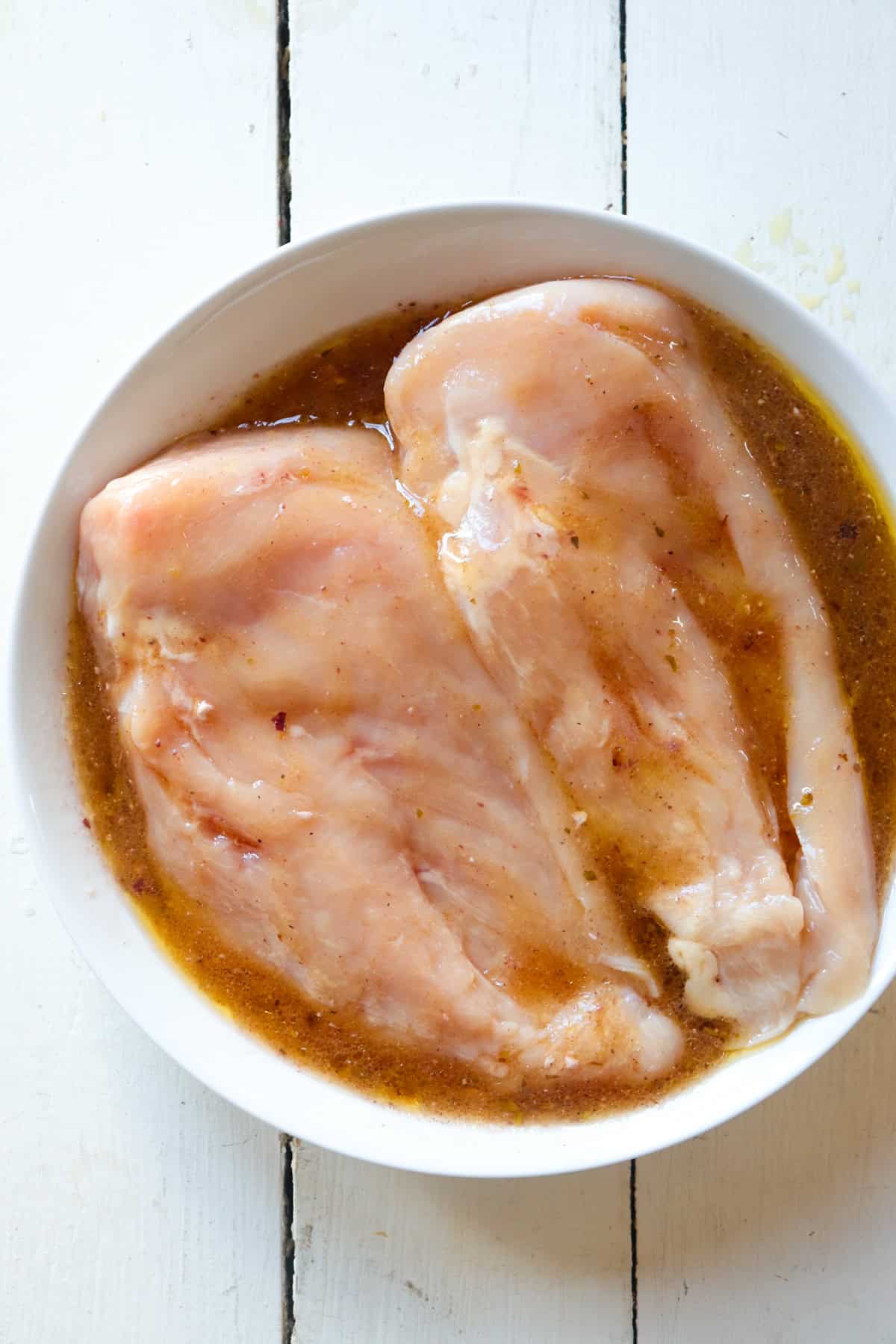 chicken breasts soaking in marinade.