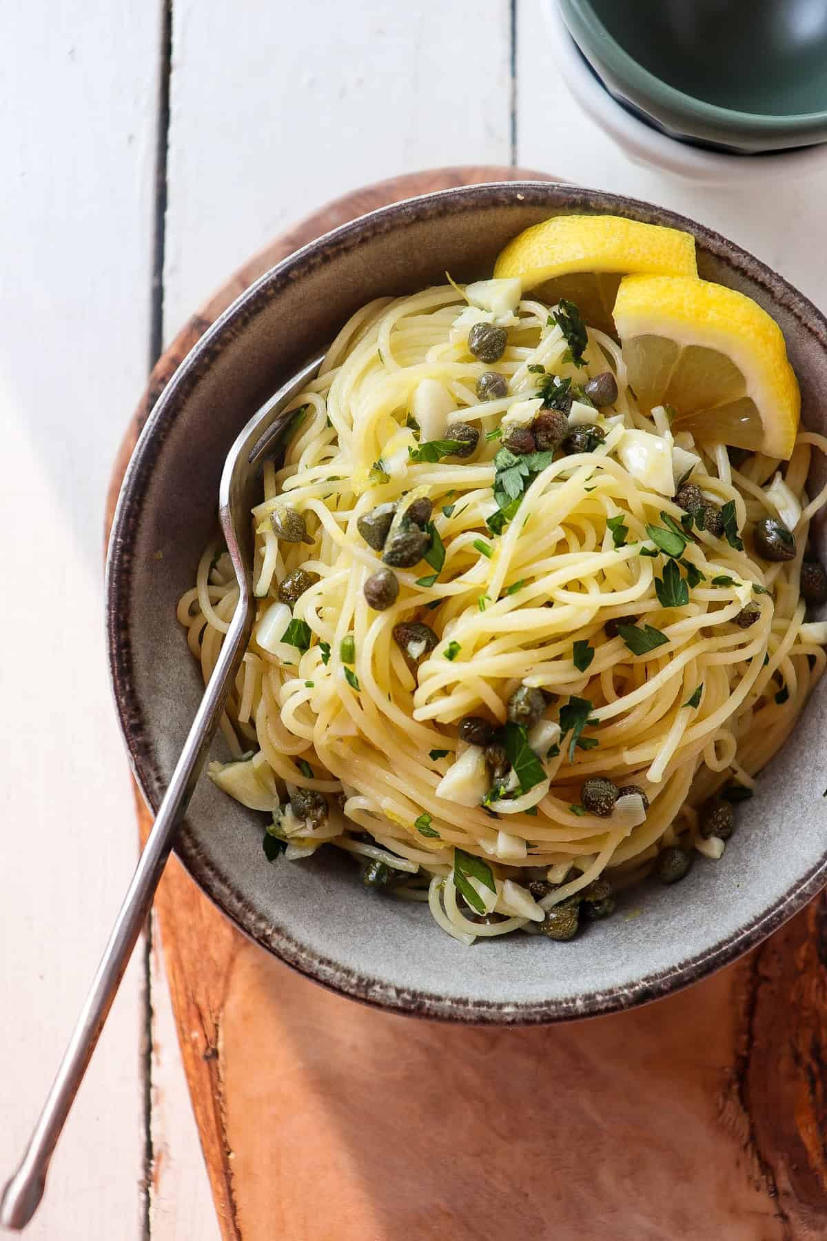 grey bowl filled with lemon caper pasta.