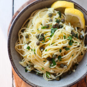 grey bowl filled with lemon caper pasta.