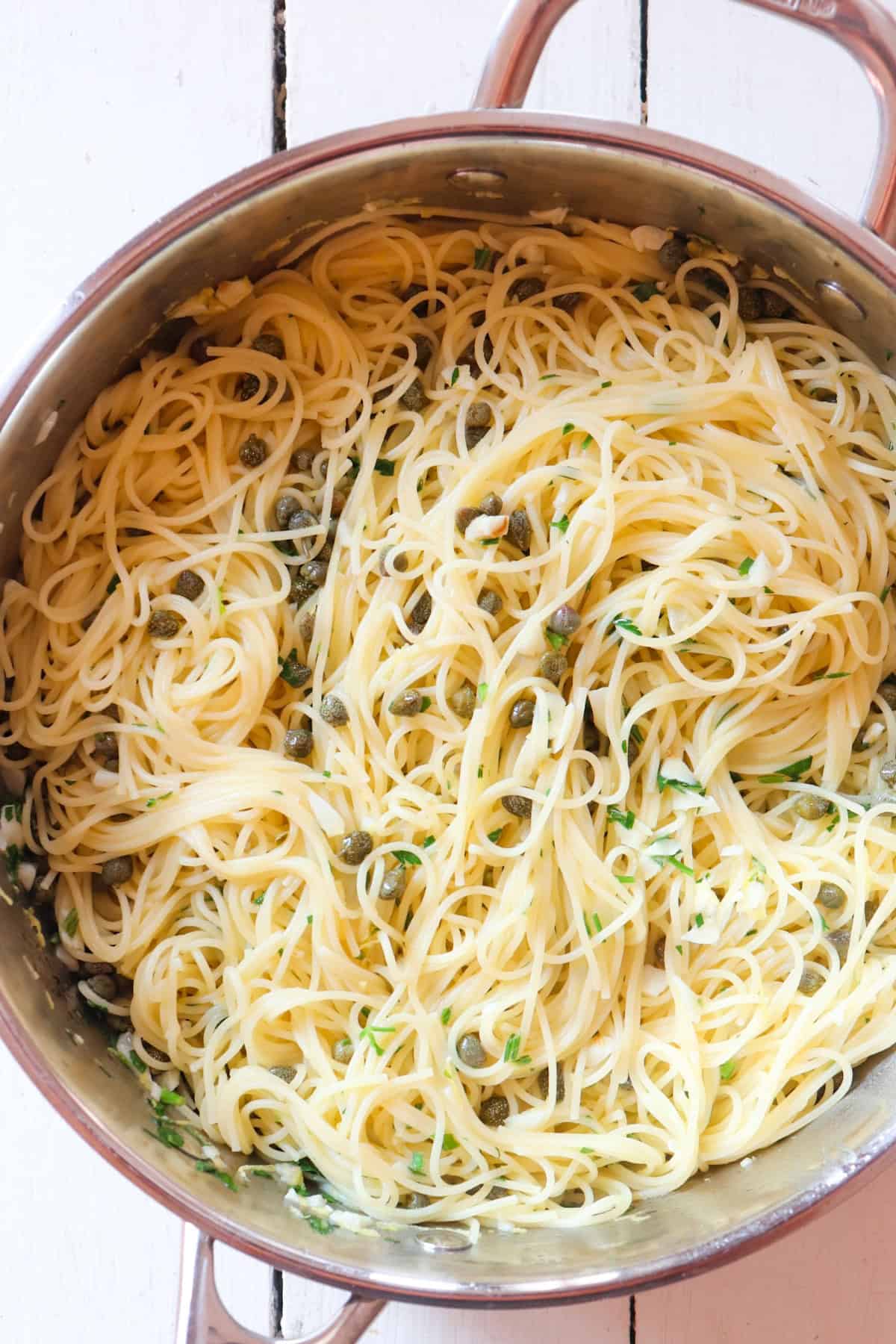 finished pasta with lemon caper sauce in a pan.