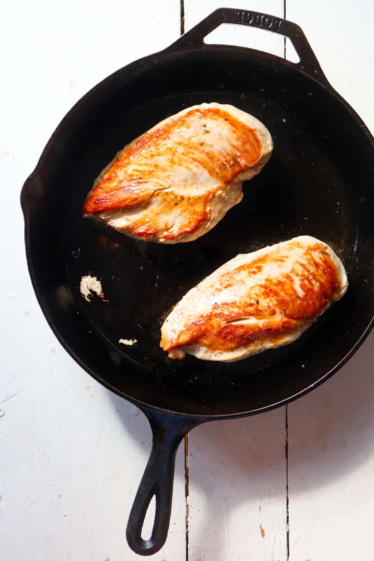 browned chicken breasts in a cast iron chicken.