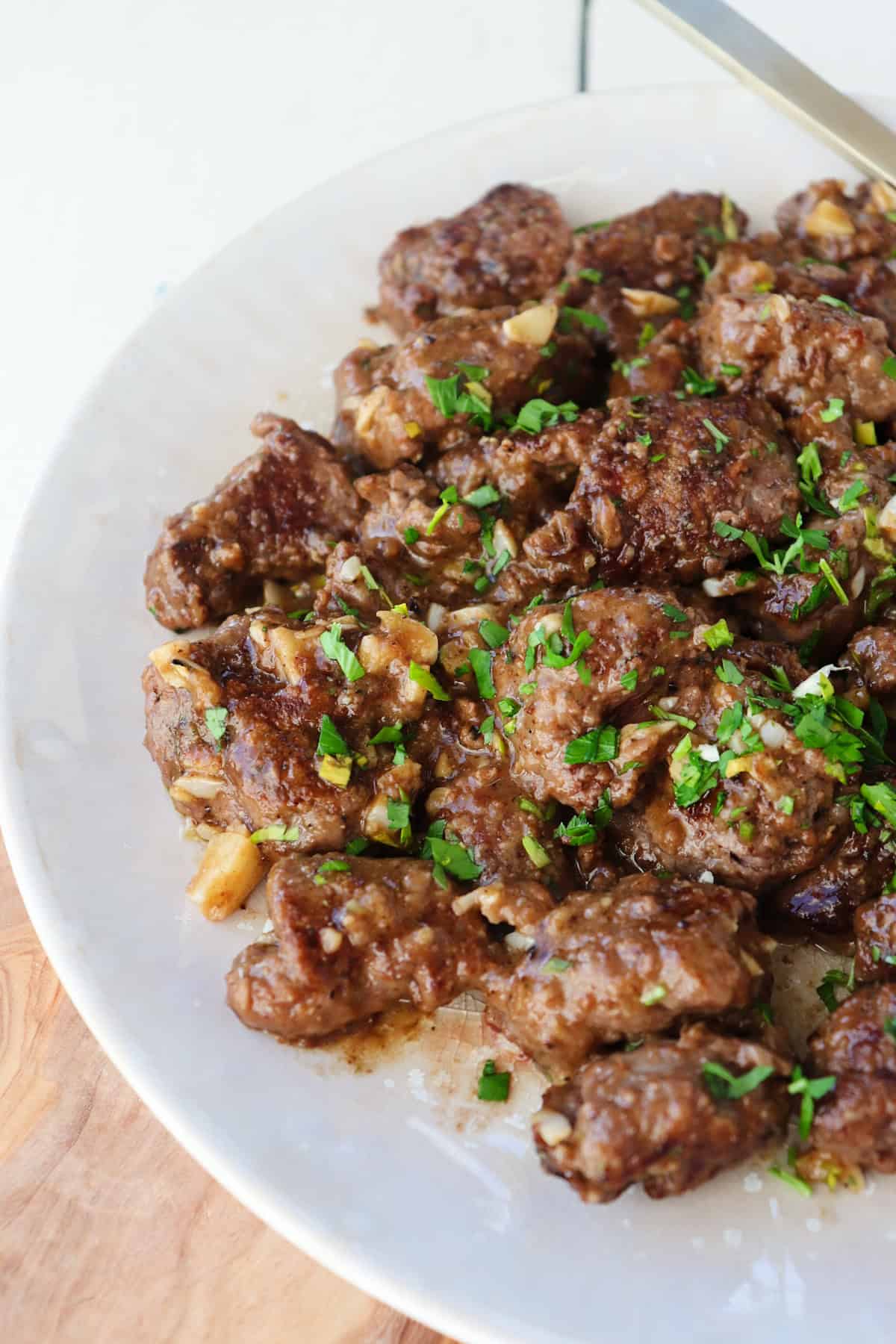 Beef tenderloin tips cooked on plate. 