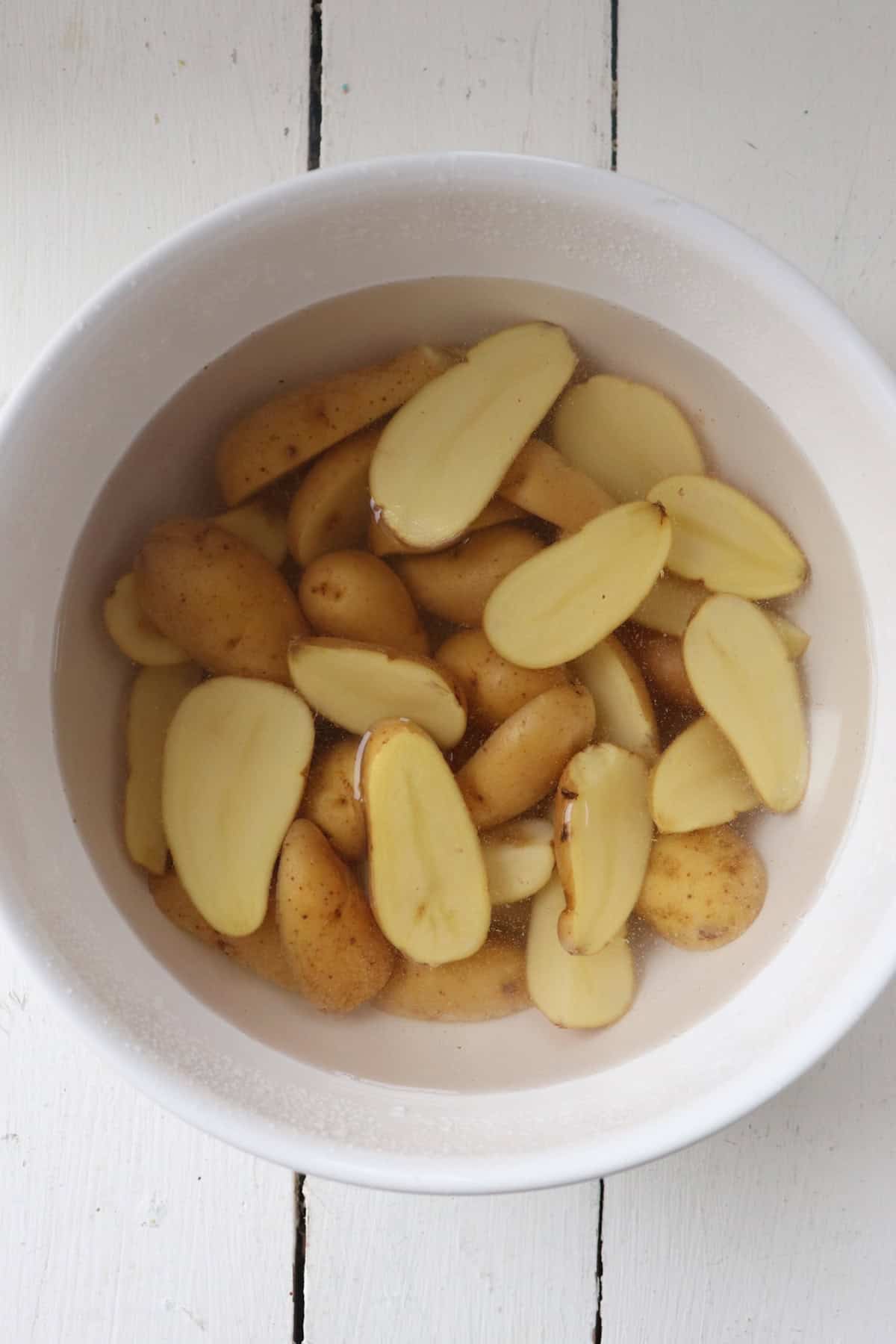 Soaked fingerling potatoes in water.