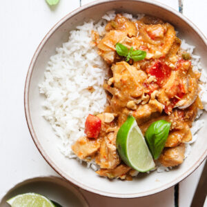 plated slow cooker chicken satay with toppings.