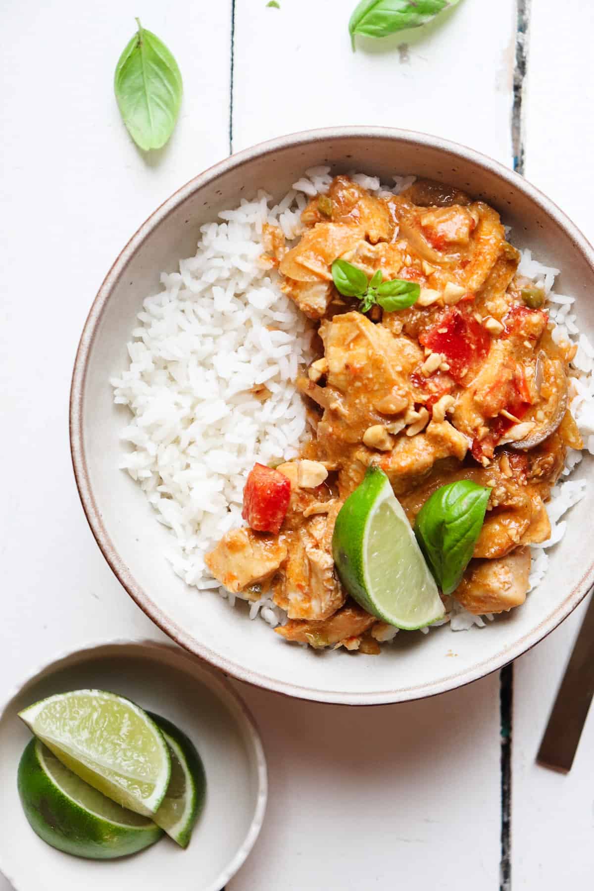 plated final dish of chicken satay with white rice and limes.