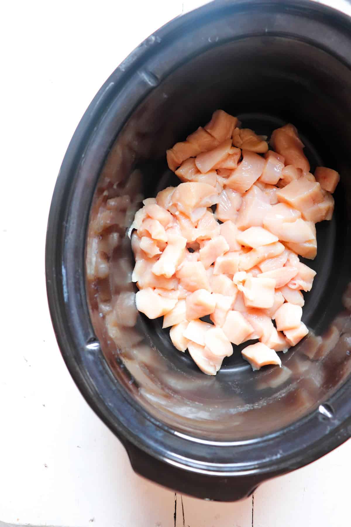 cut up chicken pieces in slow cooker