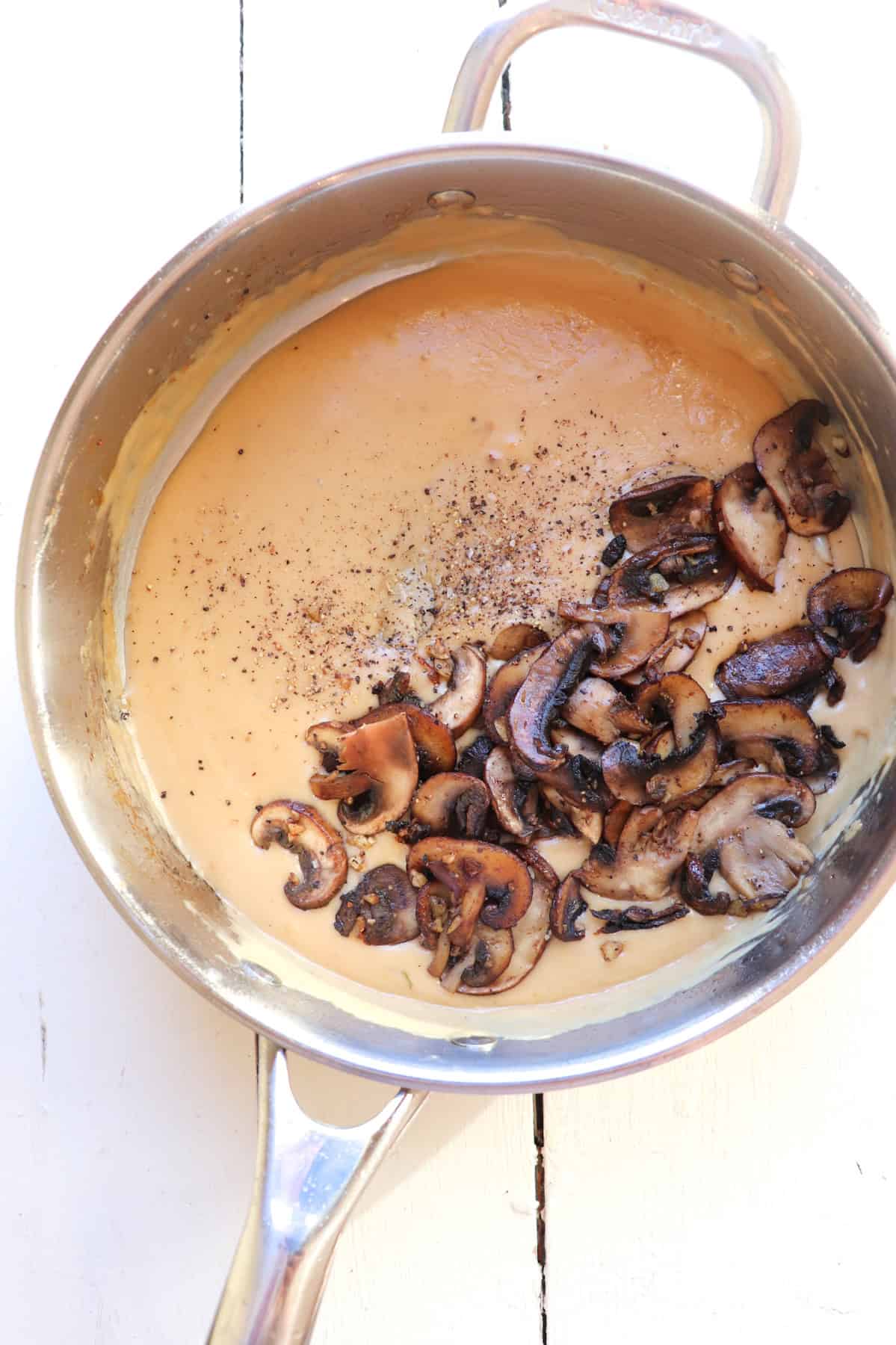 mushrooms added to marsala sauce in pan.