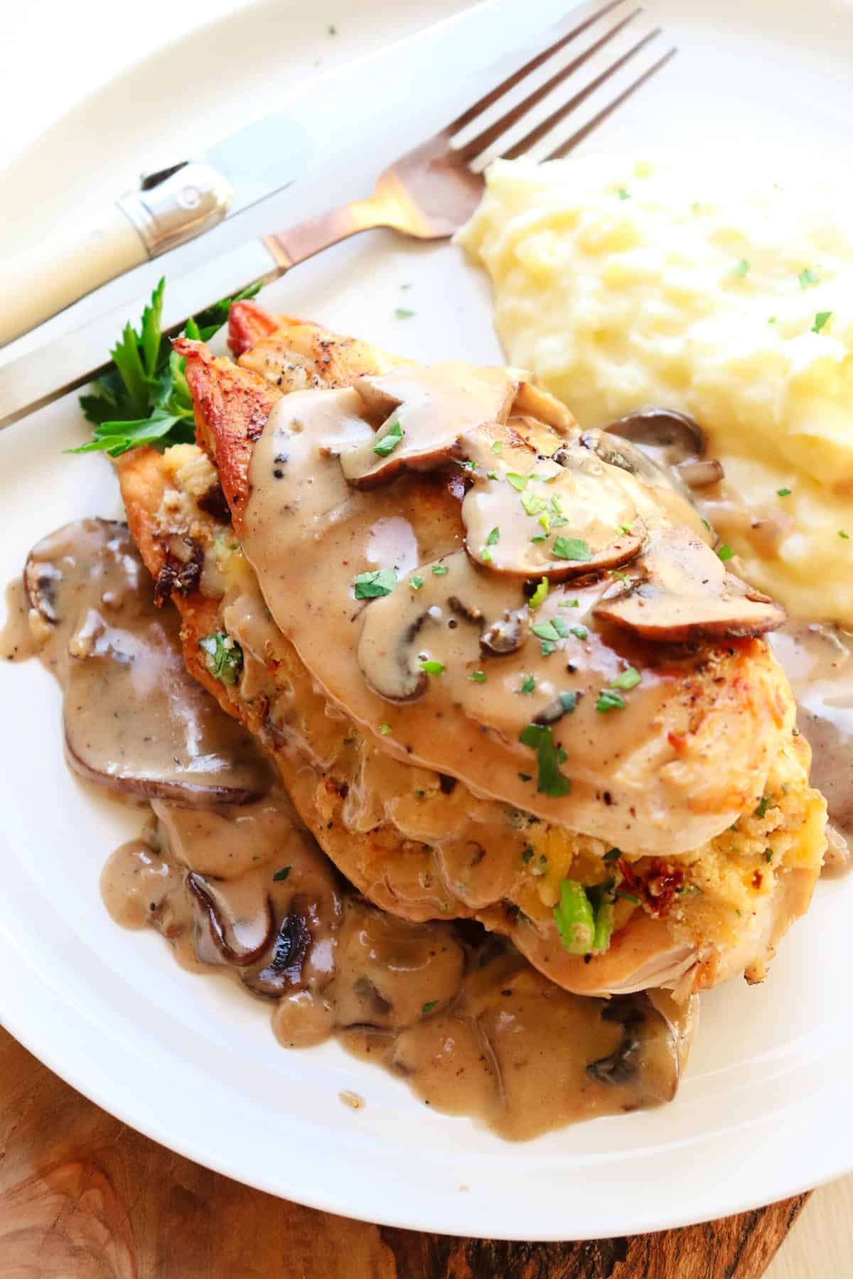 Olive Garden stuffed chicken marsala on plate with sauce.