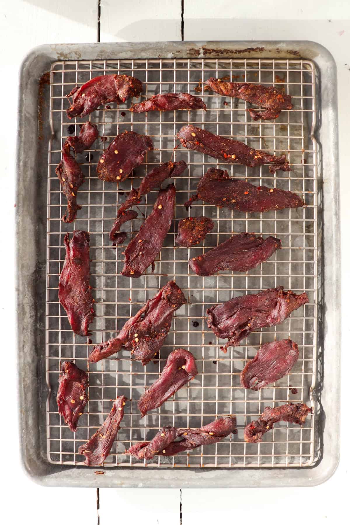 Venison jerky on dehydrating rack.