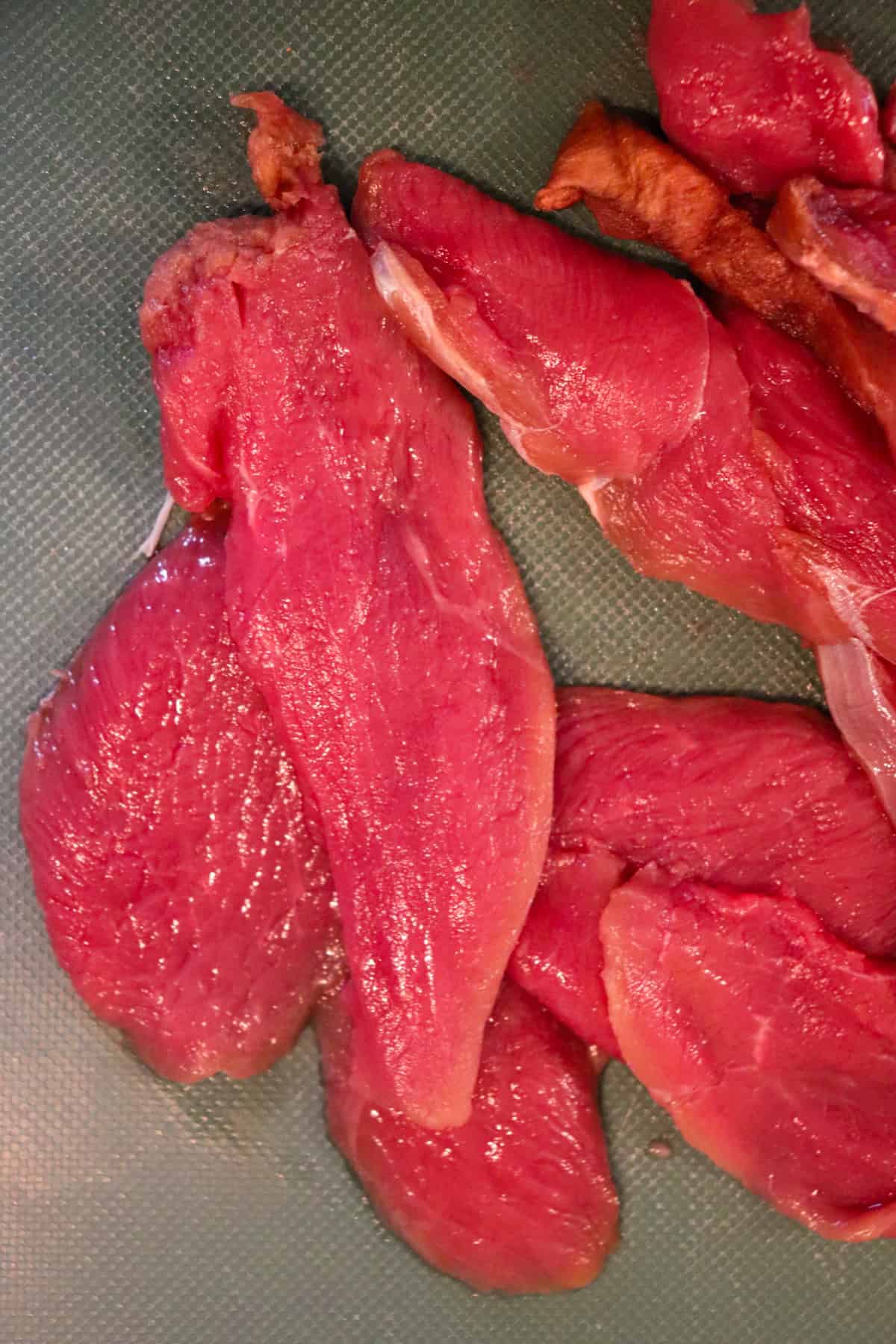 Slices of raw venison roast.