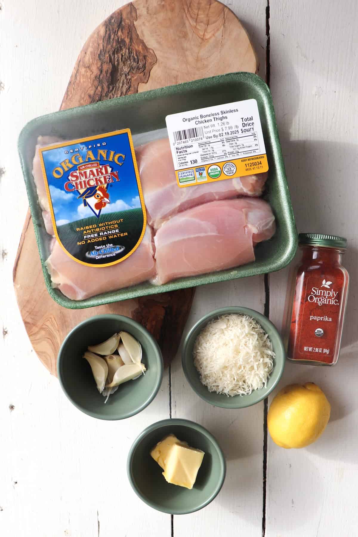 ingredients for garlic parmesan chicken thighs on a white background.