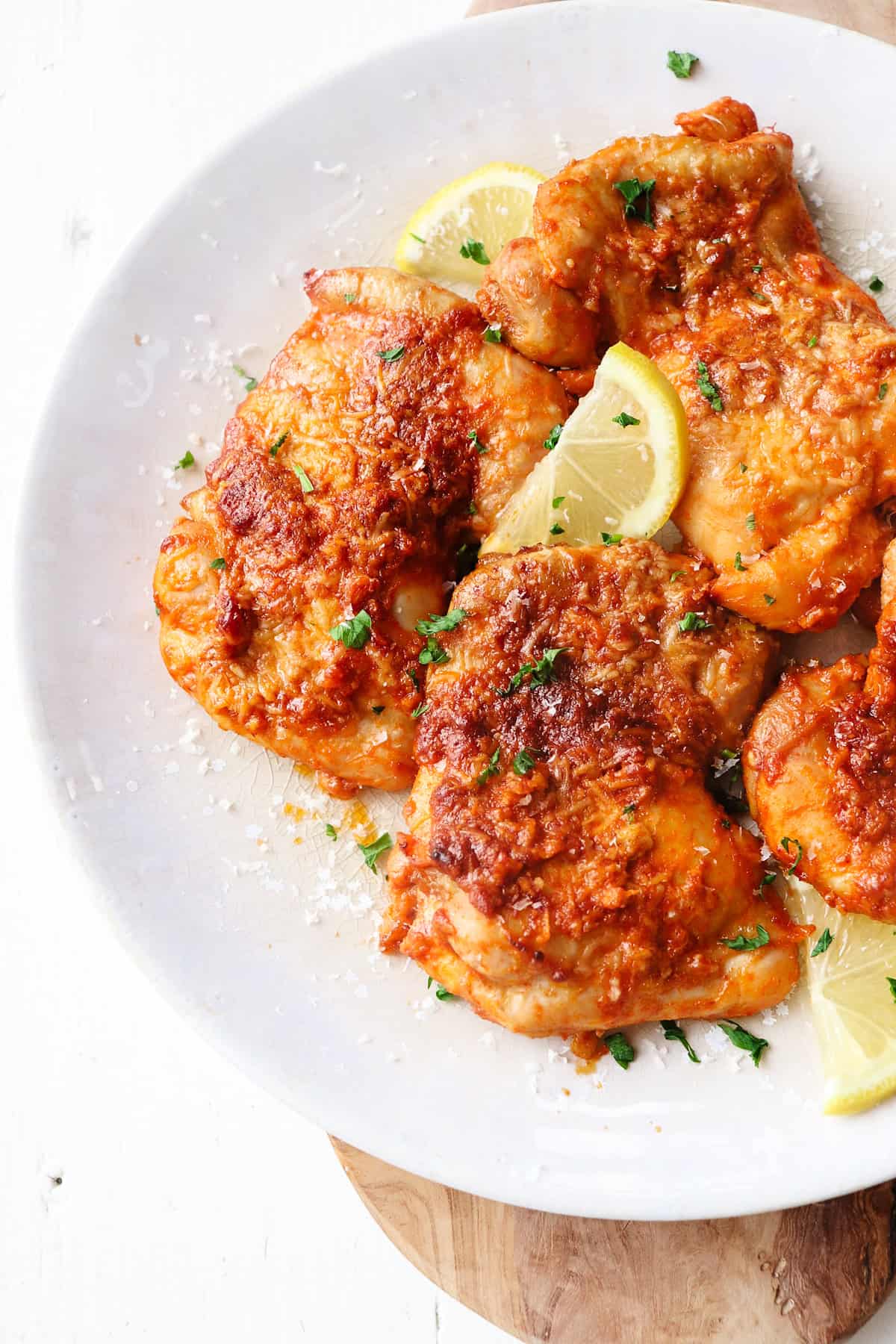 parmesan garlic chicken thighs on a plate. 