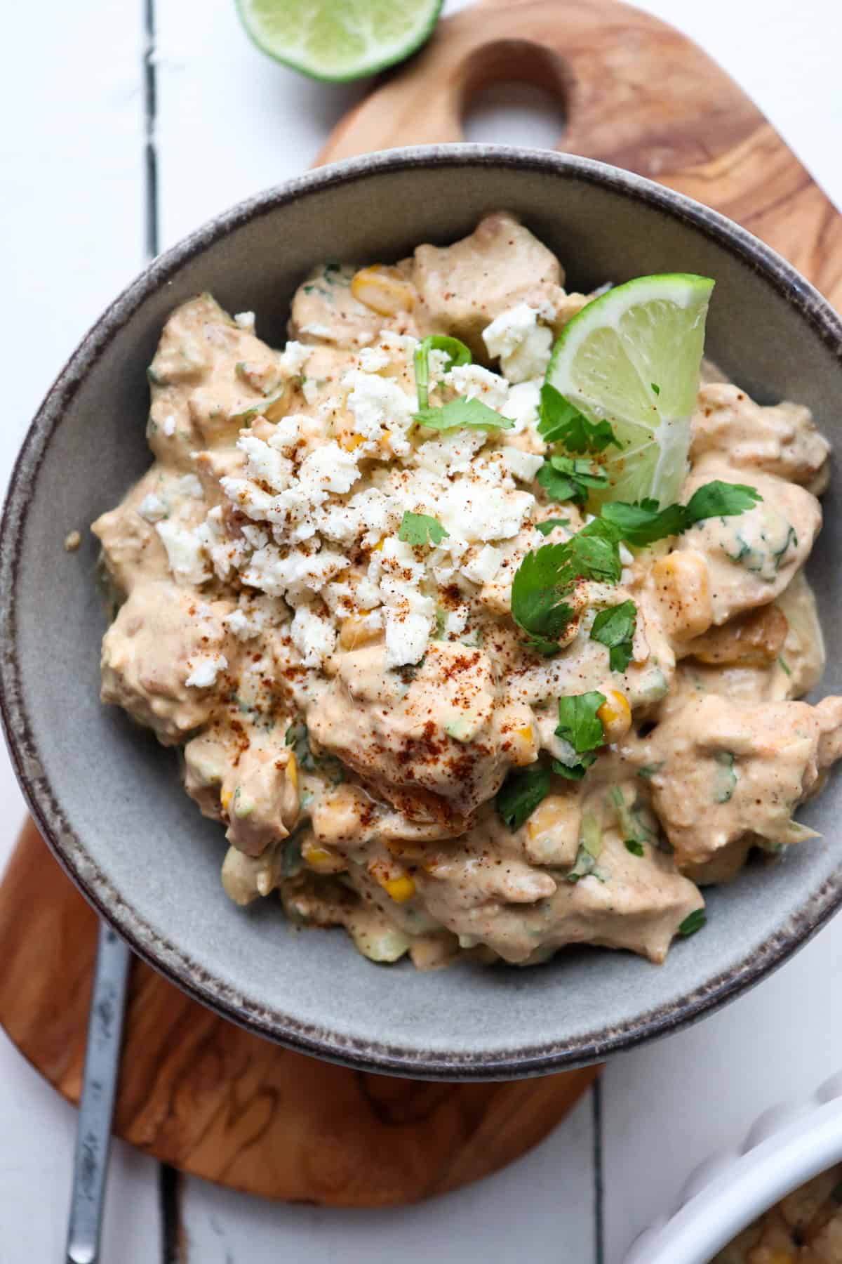 Elotes chicken salad with lime and cilantro on top.