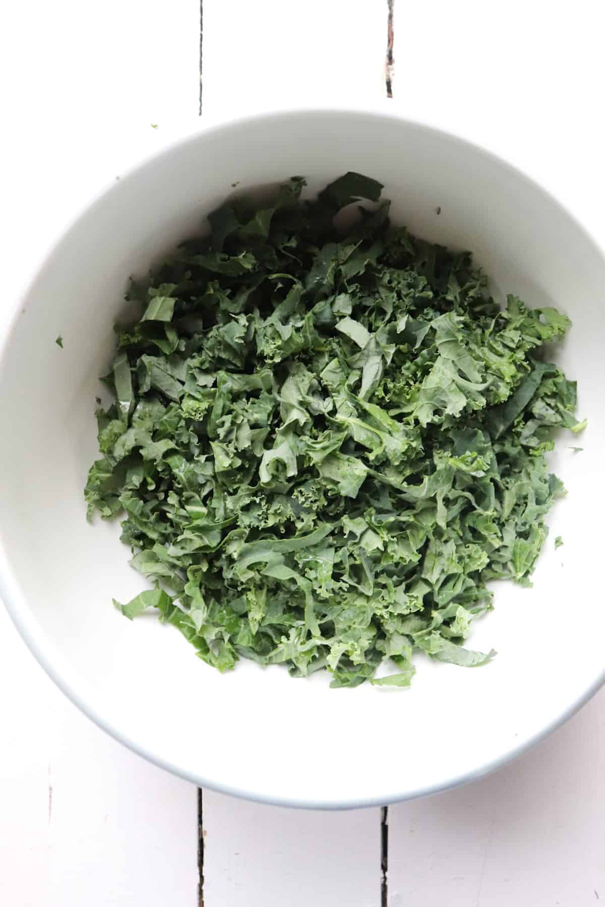 chopped kale in a white bowl