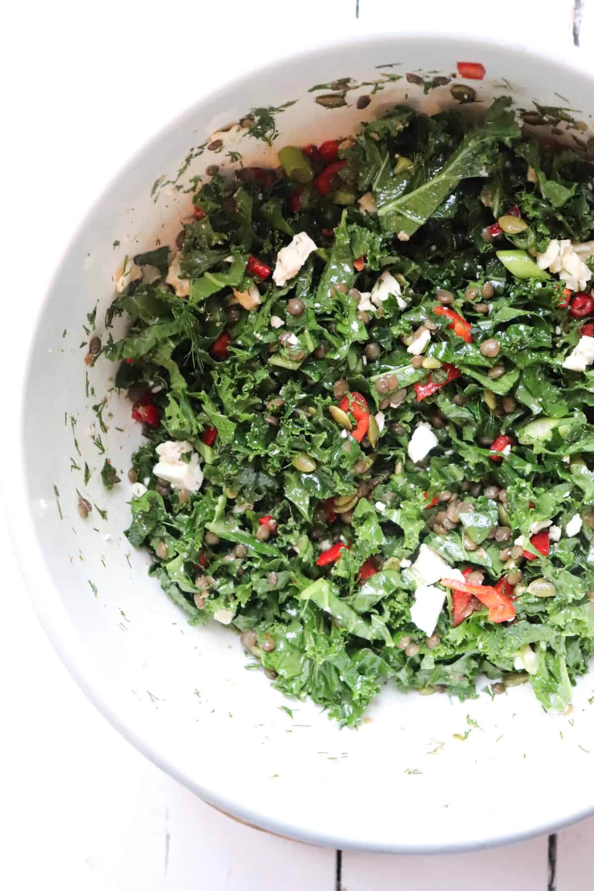 finished kale salad in a mixing bowl.
