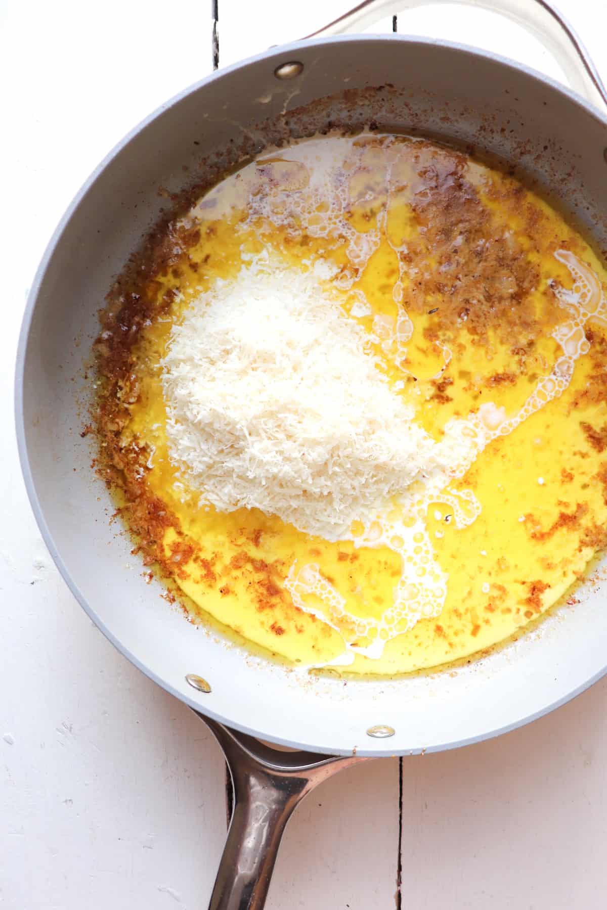 heavy cream and shredded cheese added to pan.