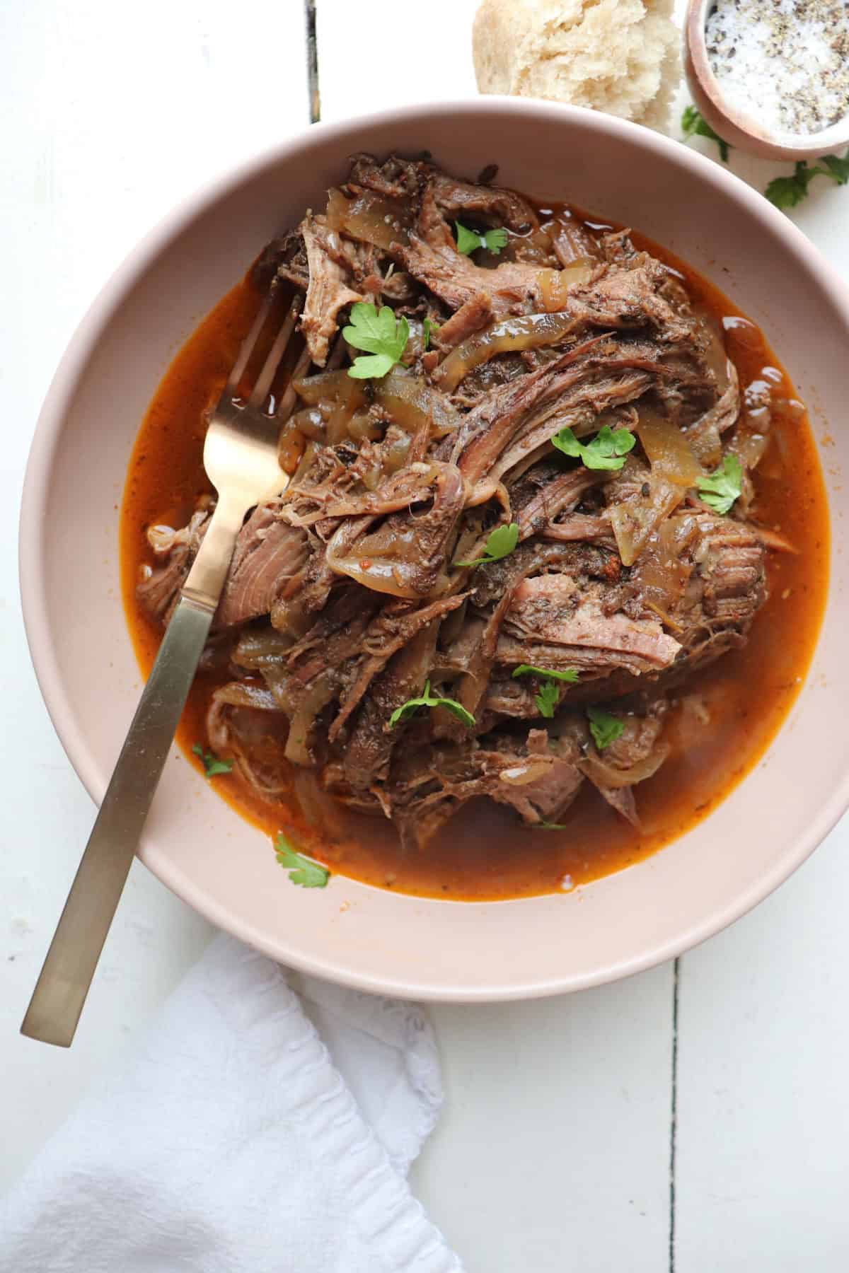finished pot roast served in a shallow dish.