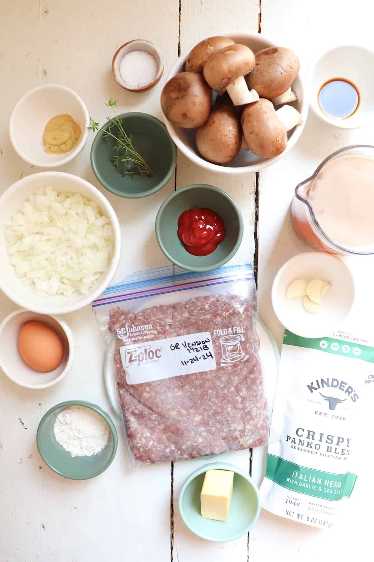 ingredients for venison salisbury steaks on a white table.