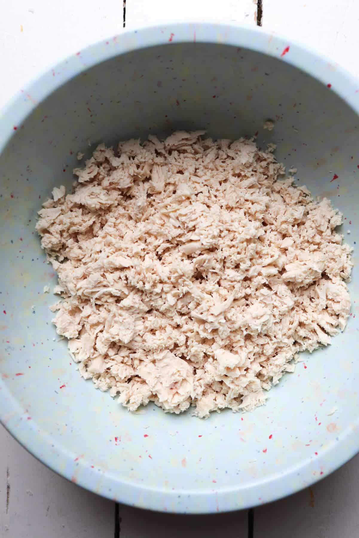 shredded chicken in a mixing bowl.