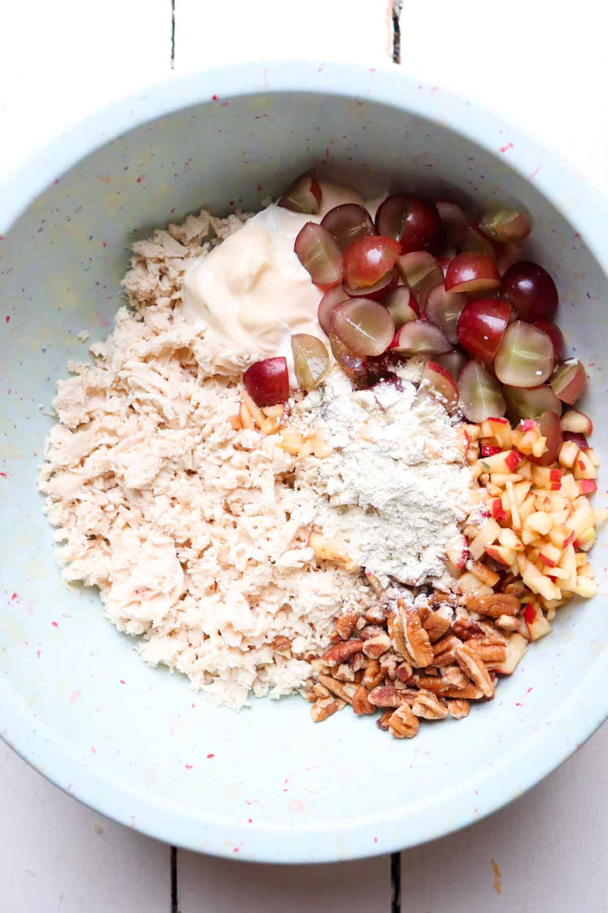 ingredients for chicken salad in a large mixing bowl.